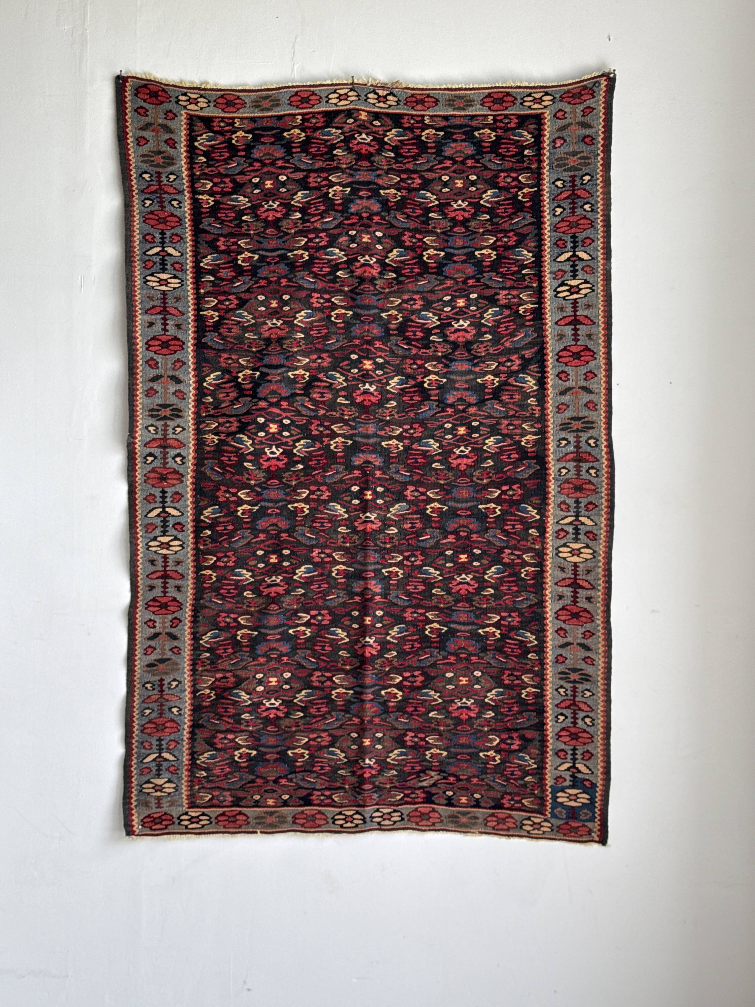 Iranian rug with stylised floral patterns in pink and blue, 155x105.