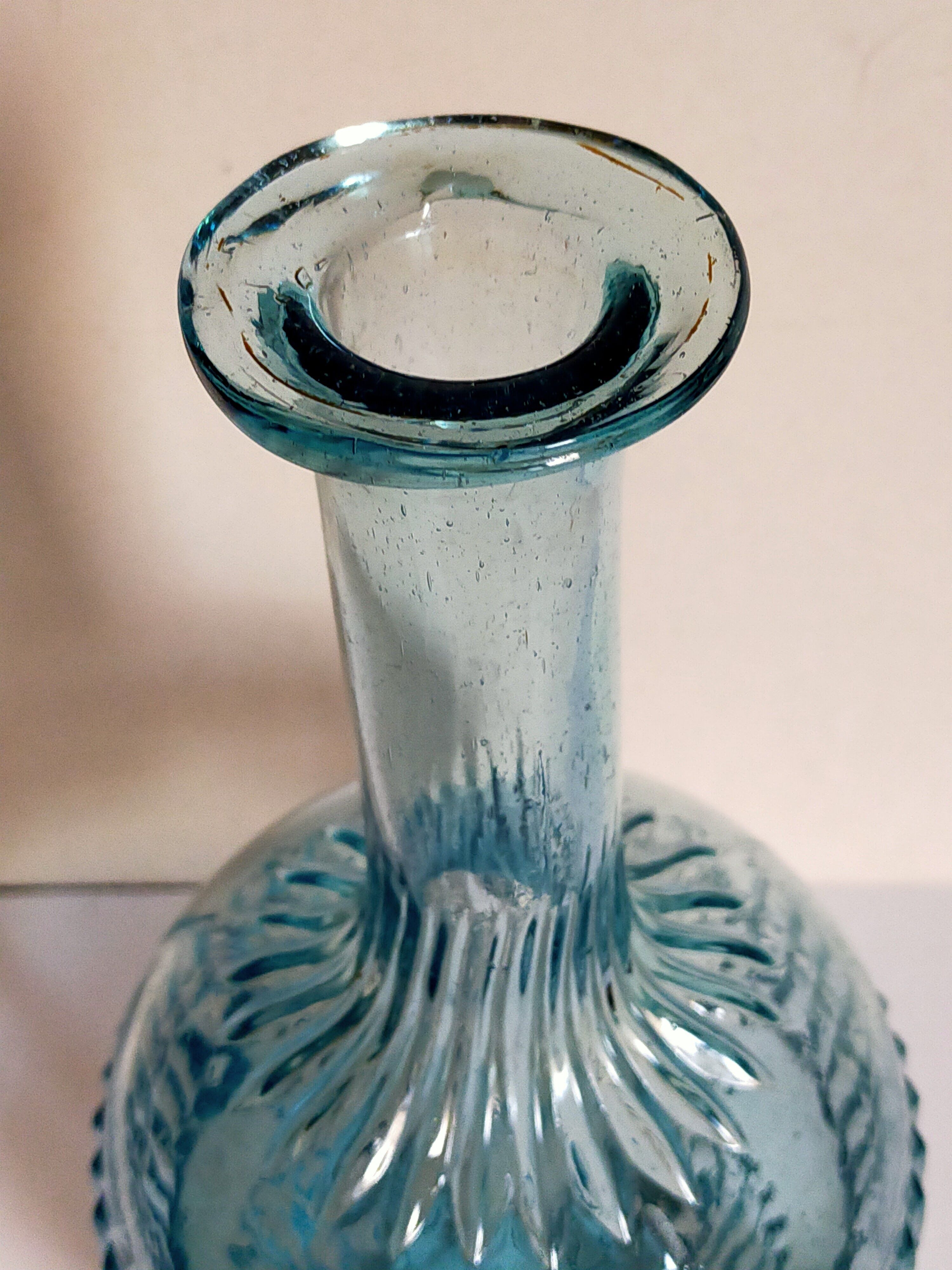 Blue glass carafe with vintage pegs