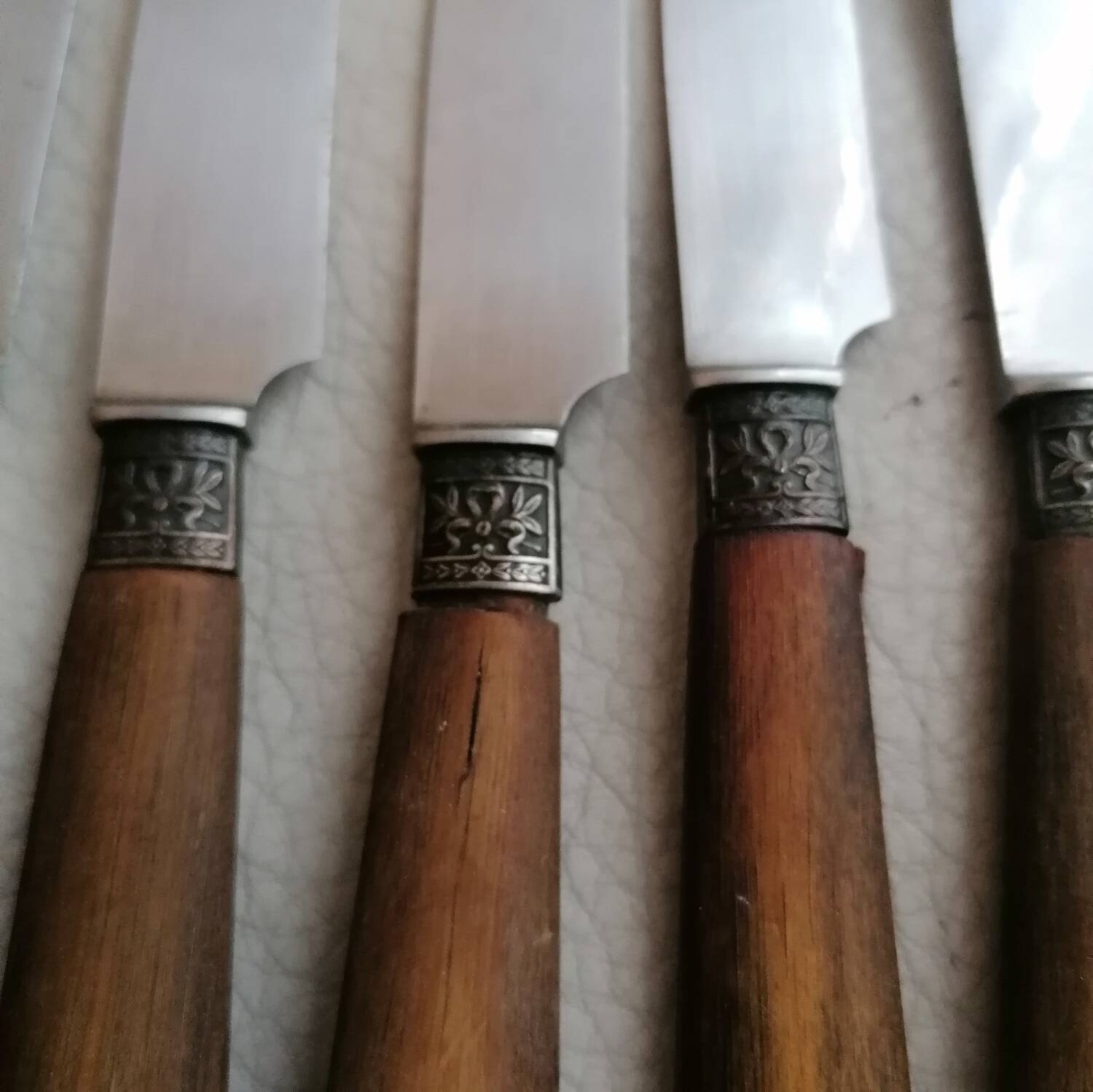 Old table knives and dessert knives, wooden handles, stainless steel blades