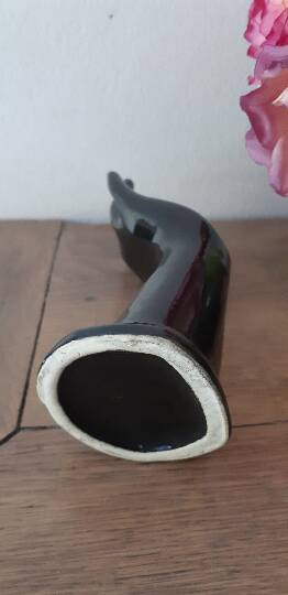 Hand holds black jewelry, ring sizer, soliflore, vintage French, 50s