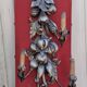 Large three-light wall sconce in silver wood with fruit decoration.