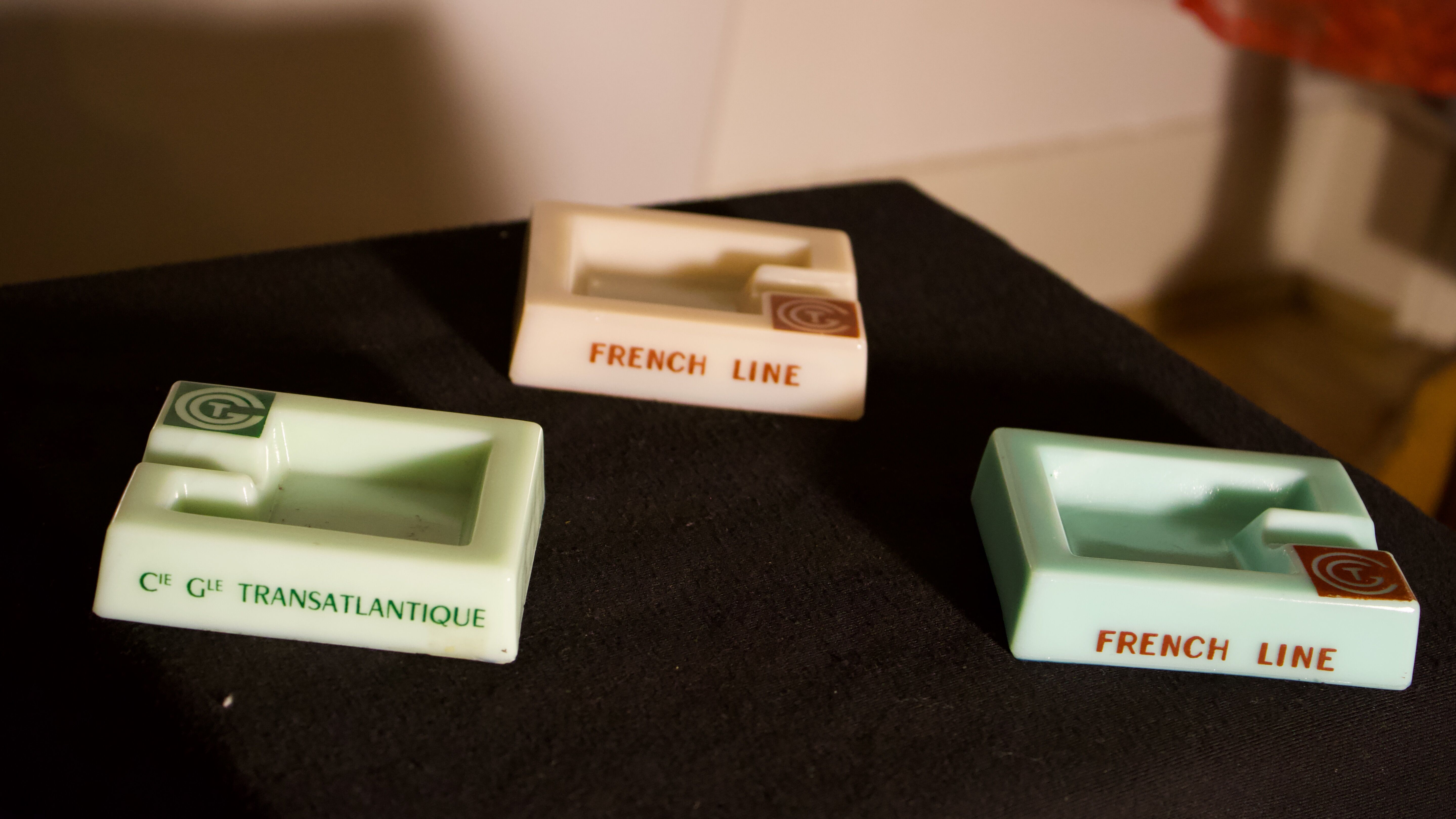 Three opalex ashtrays at the Logo of the Trans-Atlantic General Company - French Line - Model created by Jean Luce for the cruises of the liner Normandy and France