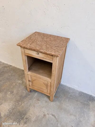 Antique wooden bedside table with a pink/orange marble top.
