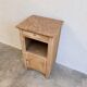 Antique wooden bedside table with a pink/orange marble top.