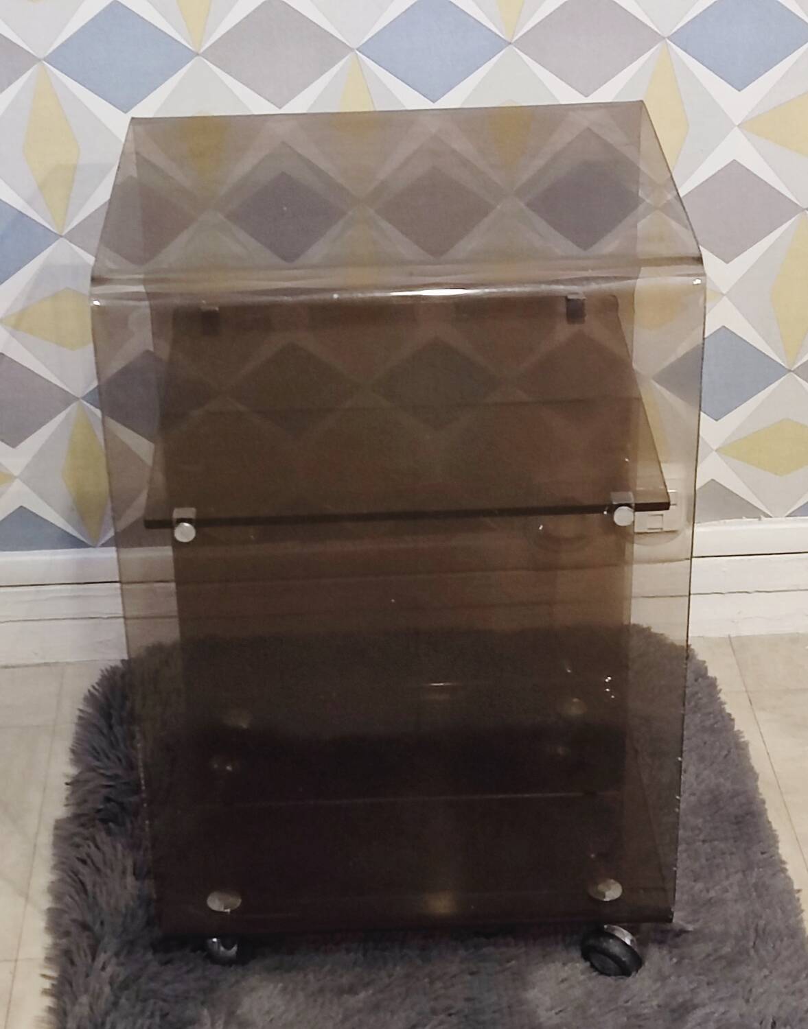 Michel Dumas smoked Plexiglas rolling table.