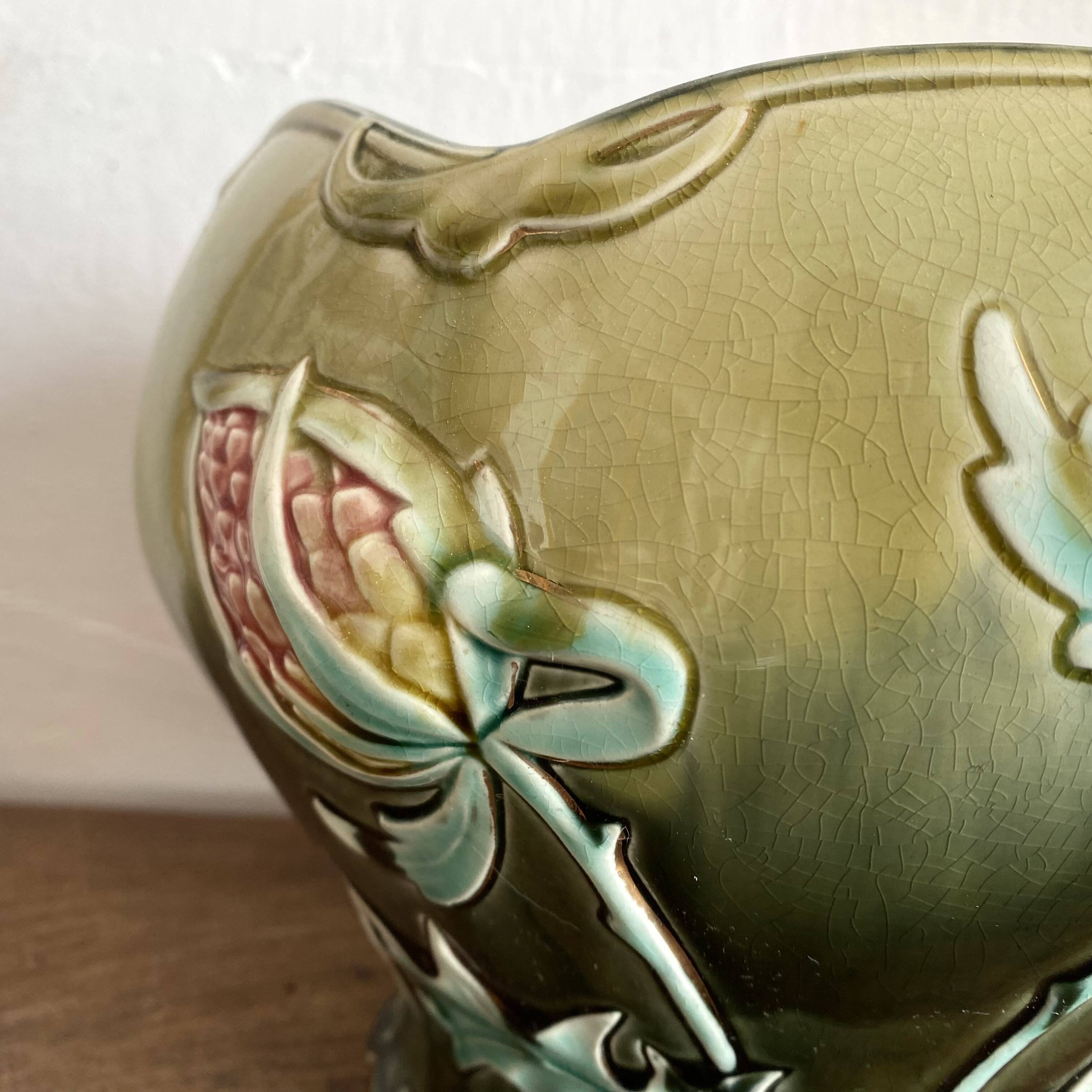 Large earthenware cache-pot in Art Nouveau style, decorated with thistles.