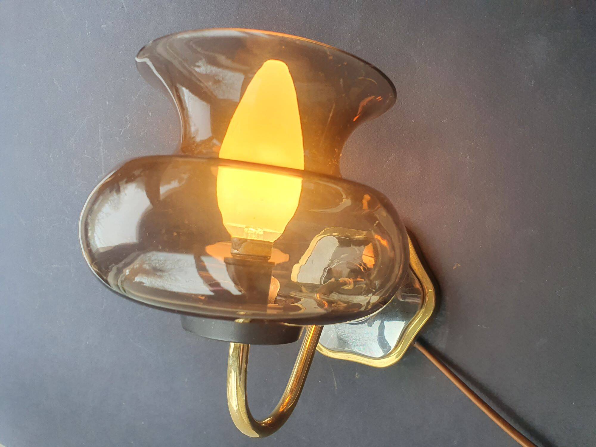 Pair of antique gold-plated brass and smoked glass wall lights.