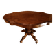 Antique mahogany table with a scalloped top and a sculpted central leg.