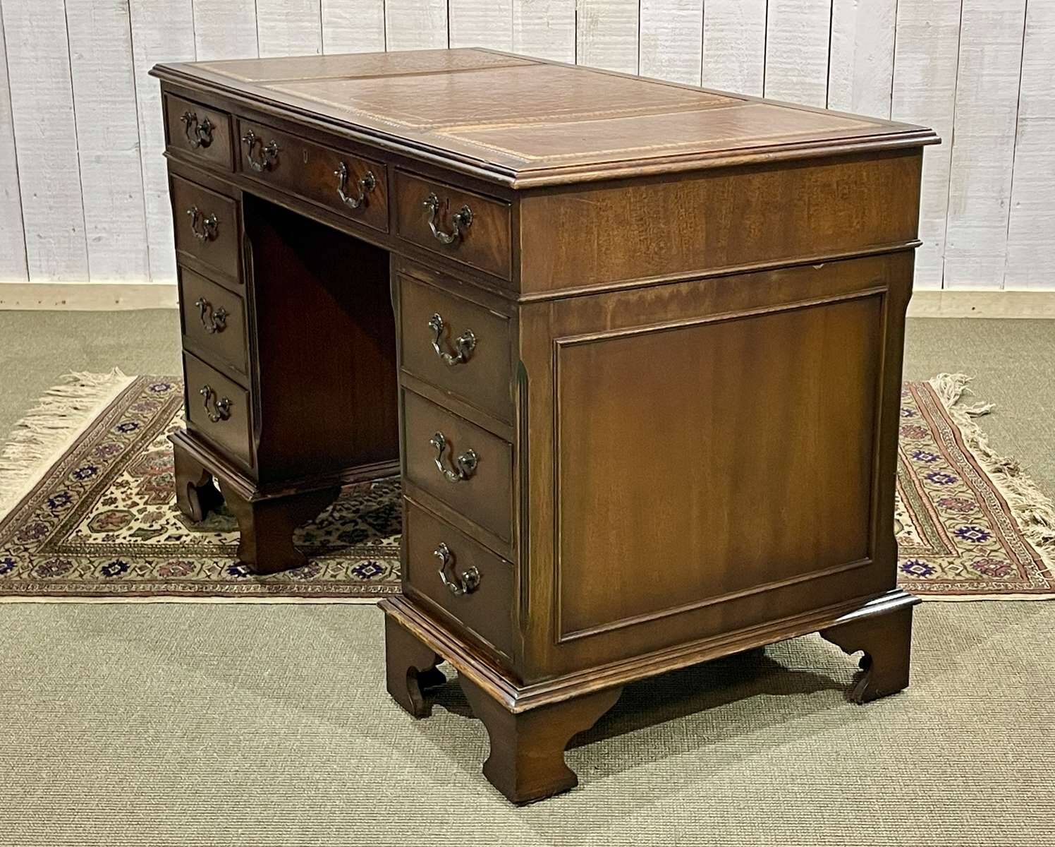 English mahogany pedestal desk with leather top from the 1950s