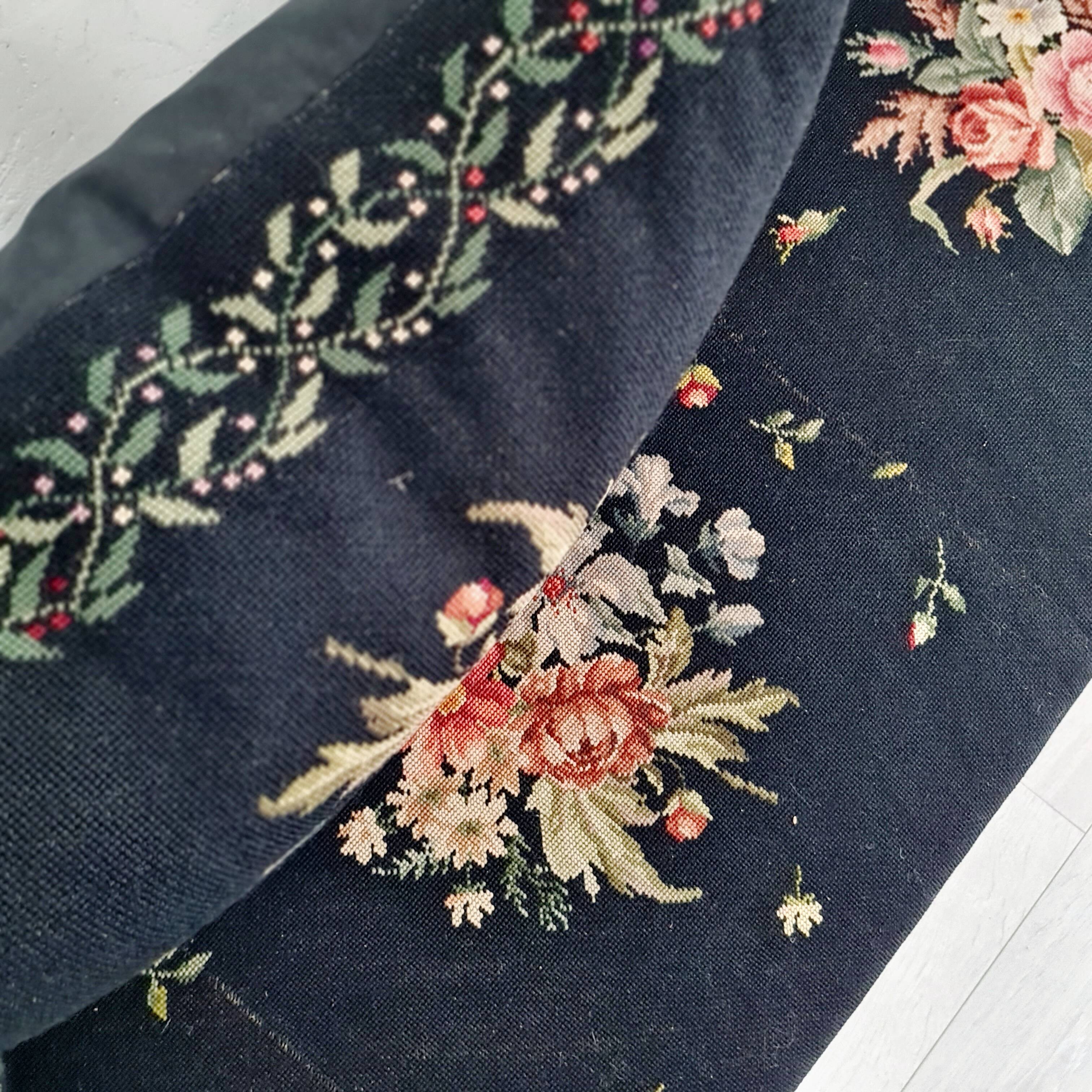 Old bench upholstered in black canvas flowers