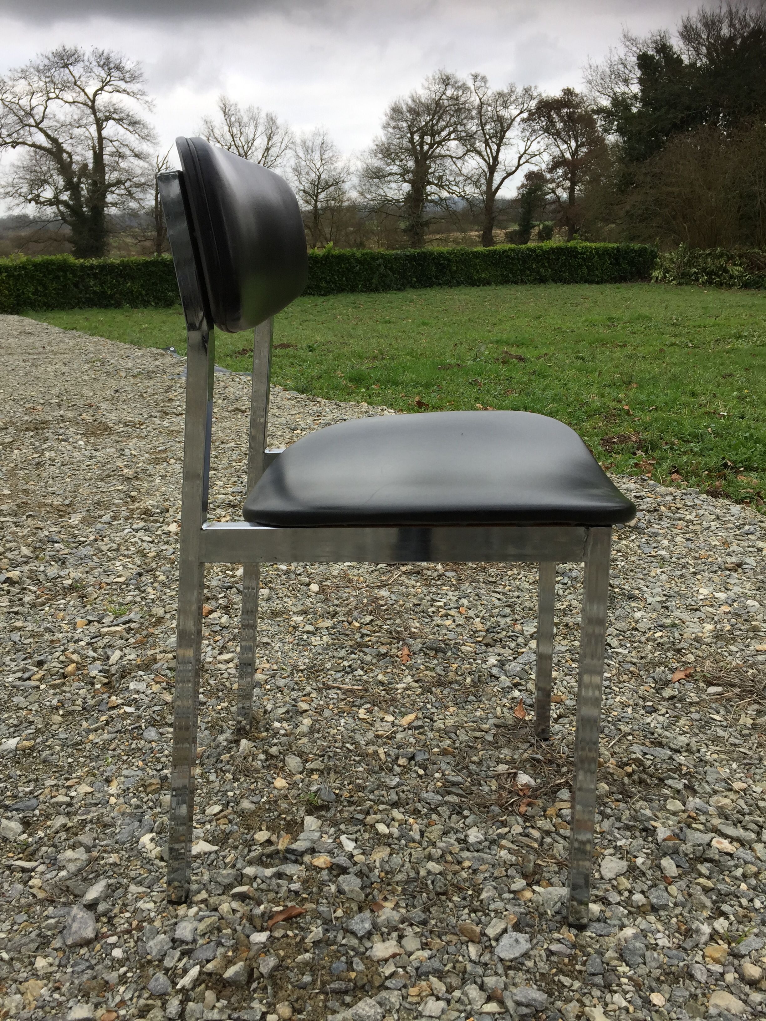 6 vintage chairs in black skaï with chrome metal tubular base.