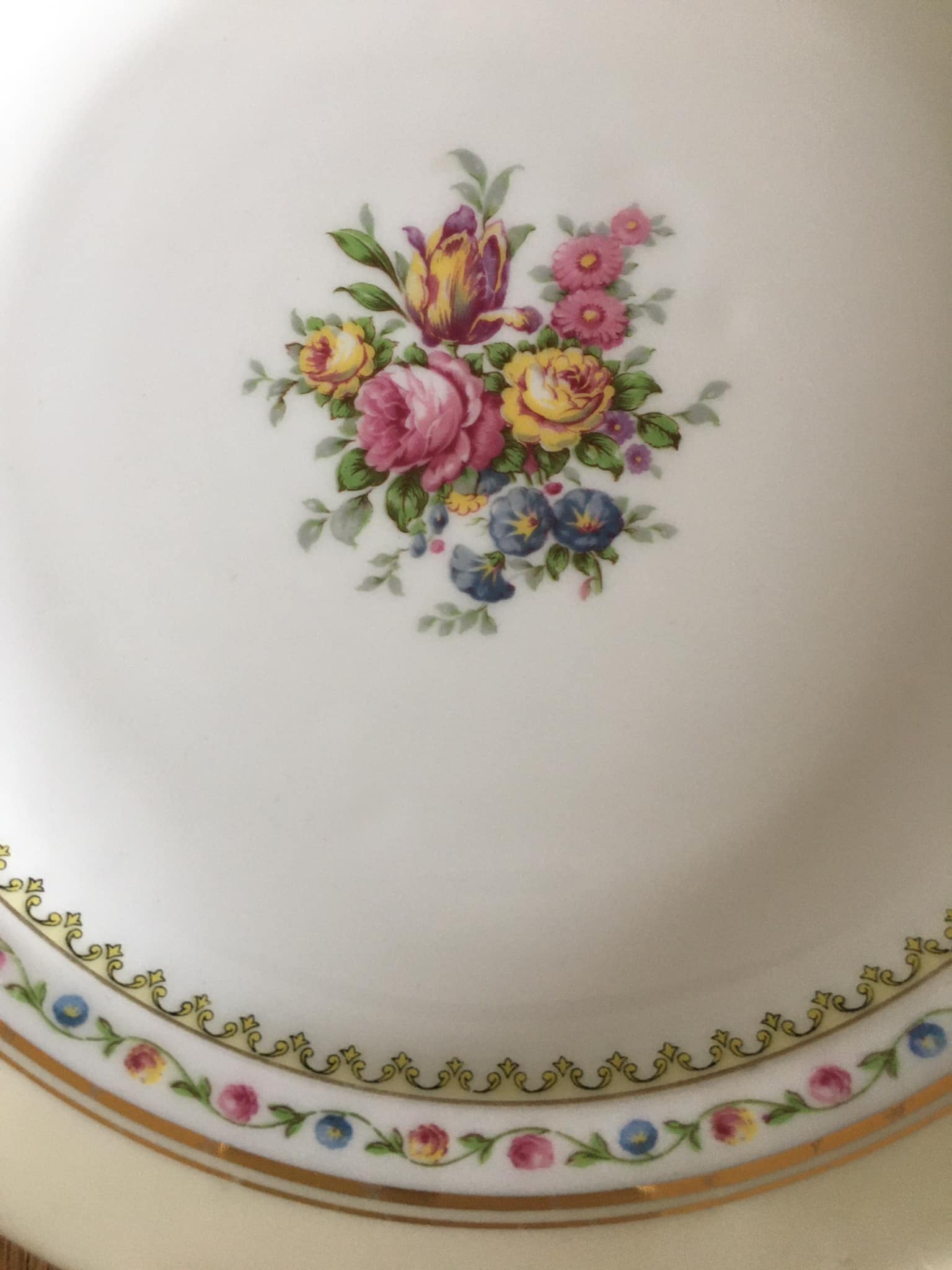4 mismatched flat plates with floral patterns. Porcelain. Stamped