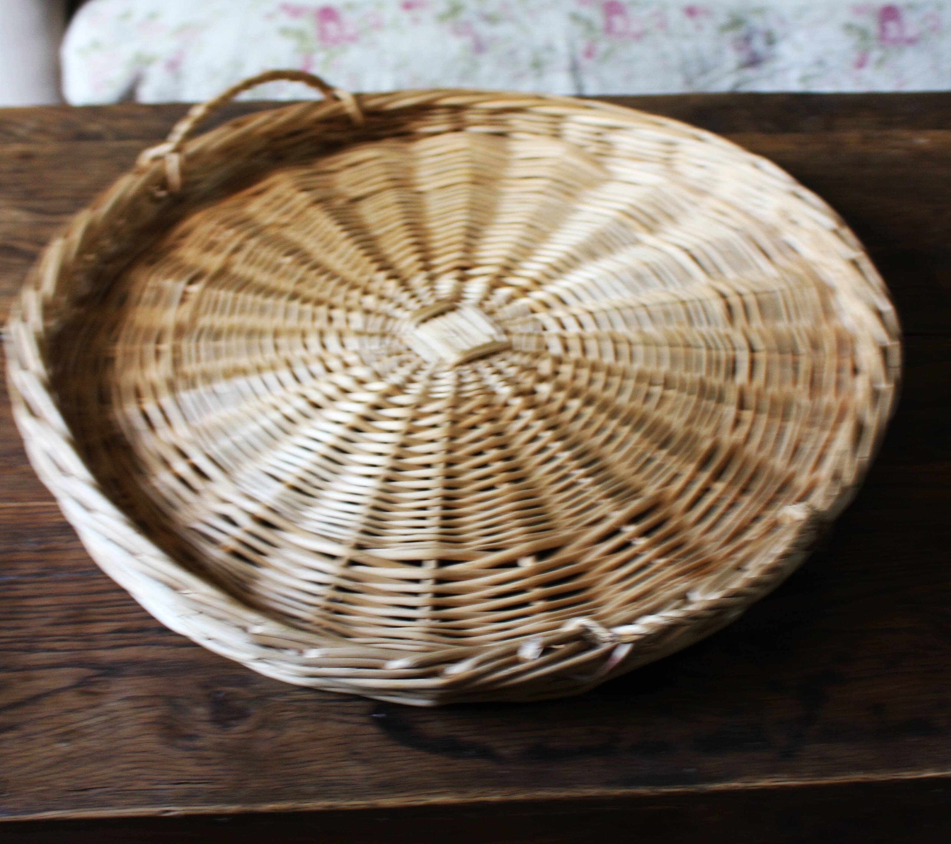 Large round wicker tray with two handles, vintage weaving.