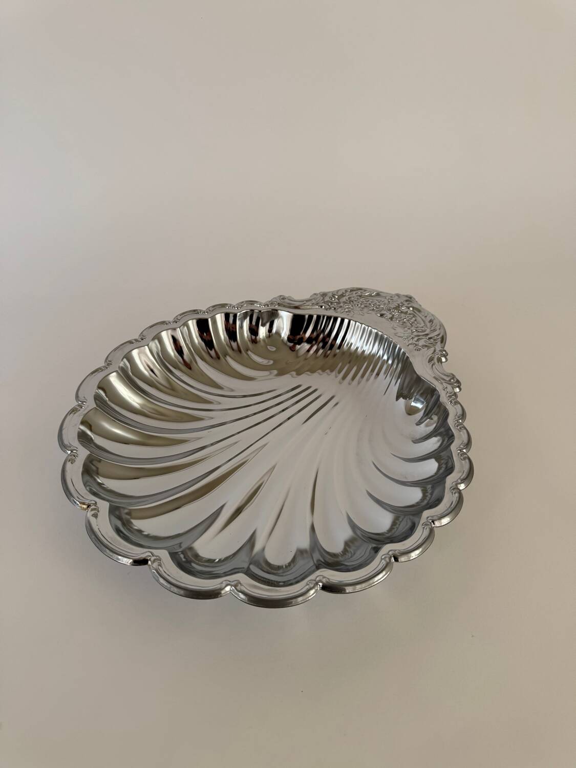 Large silver-plated serving dish in the shape of a vintage shell.