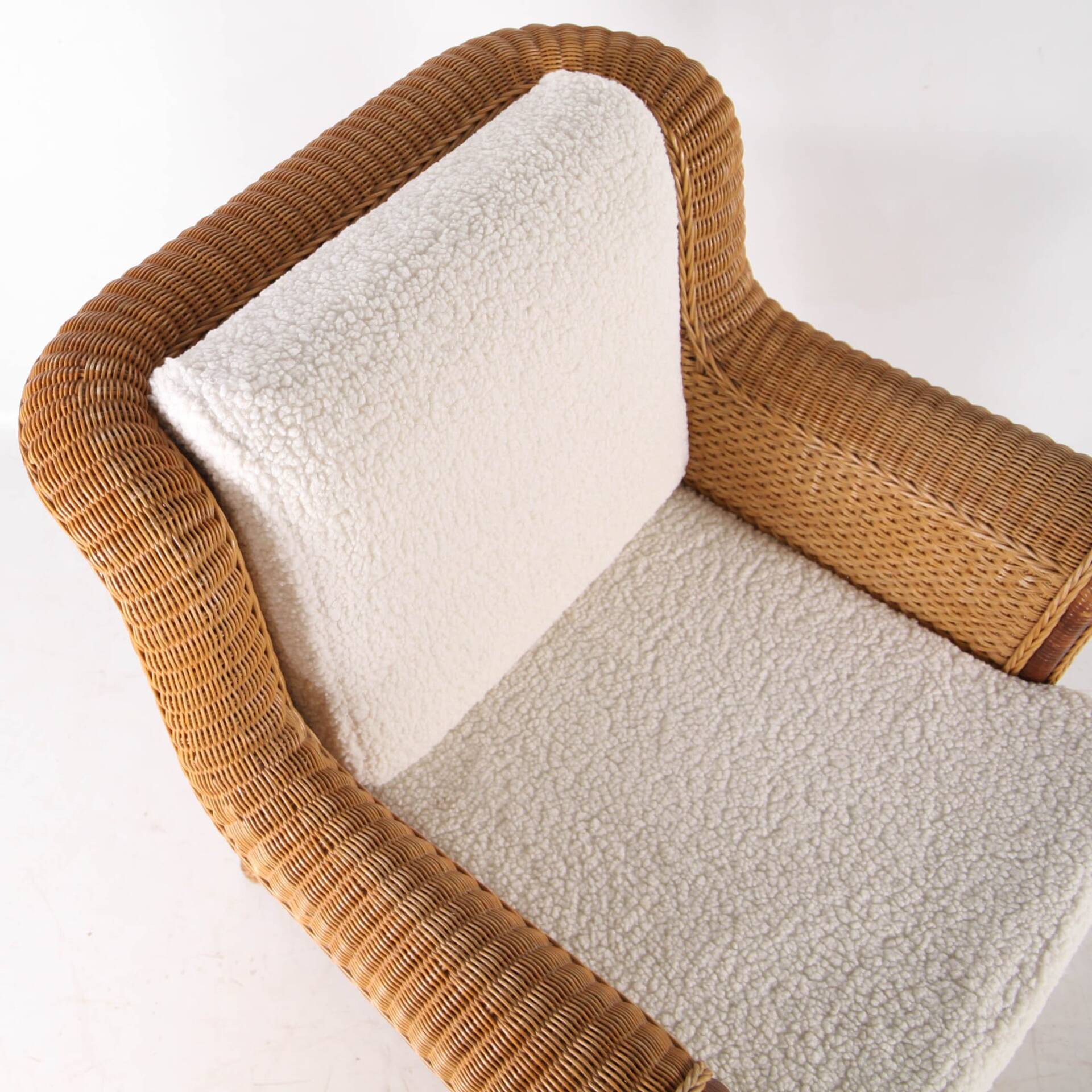 Large wicker armchair and its ottoman