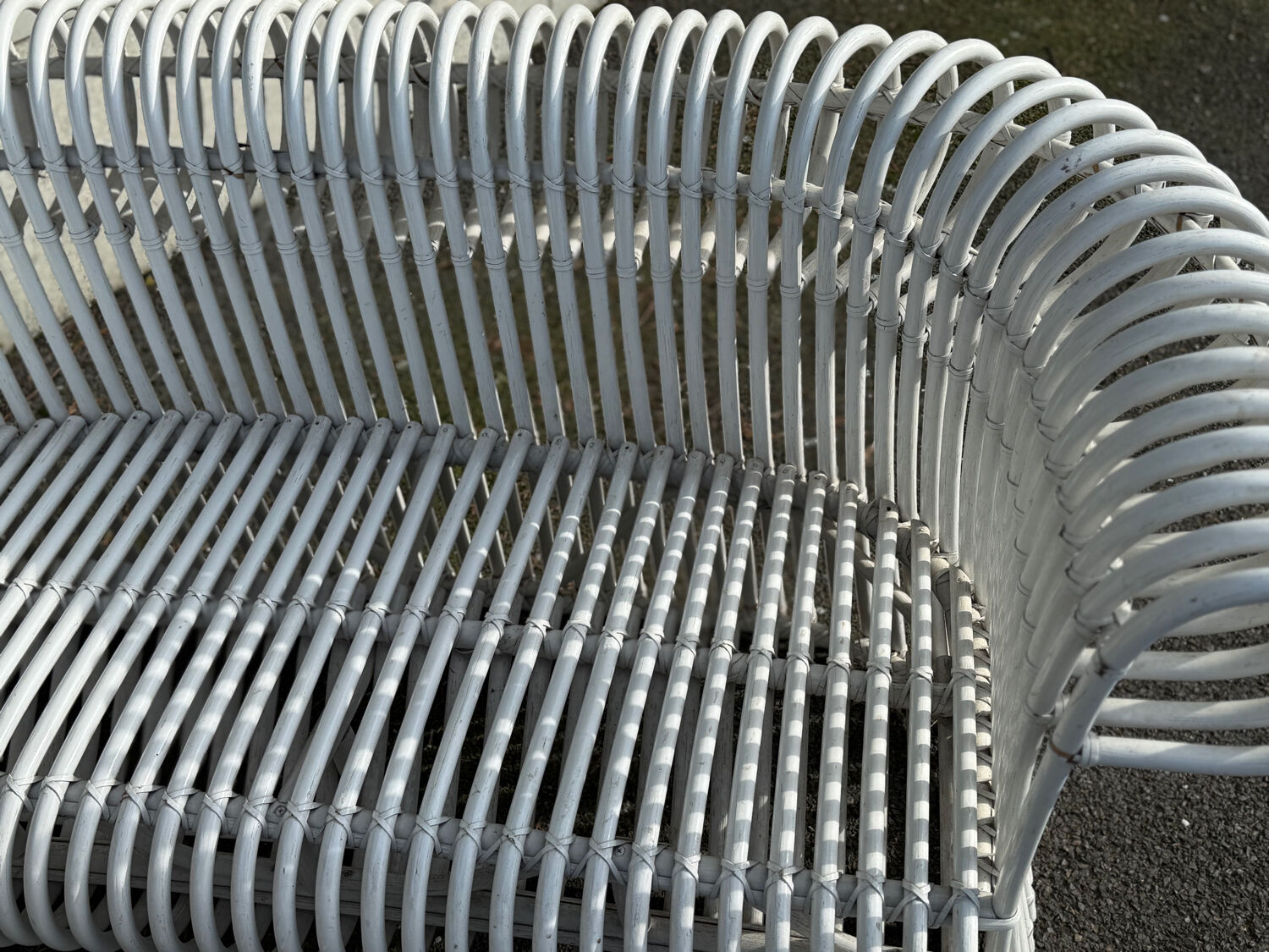 Rattan lounge with two two-seater sofas and a white coffee table.