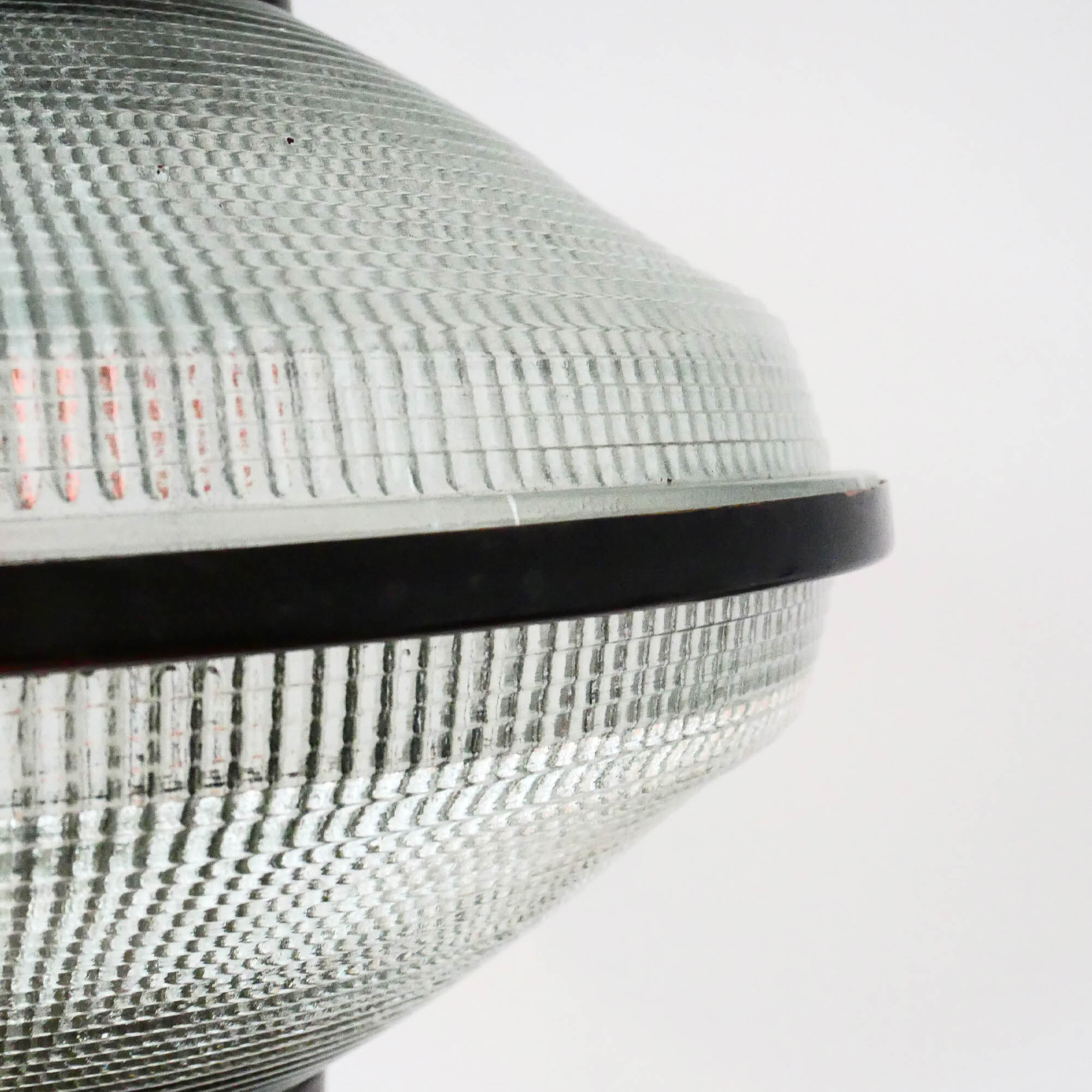 “Ellipse” pendant light in glass and patinated brass.