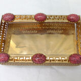 Empty pocket in gold metal and pink stones