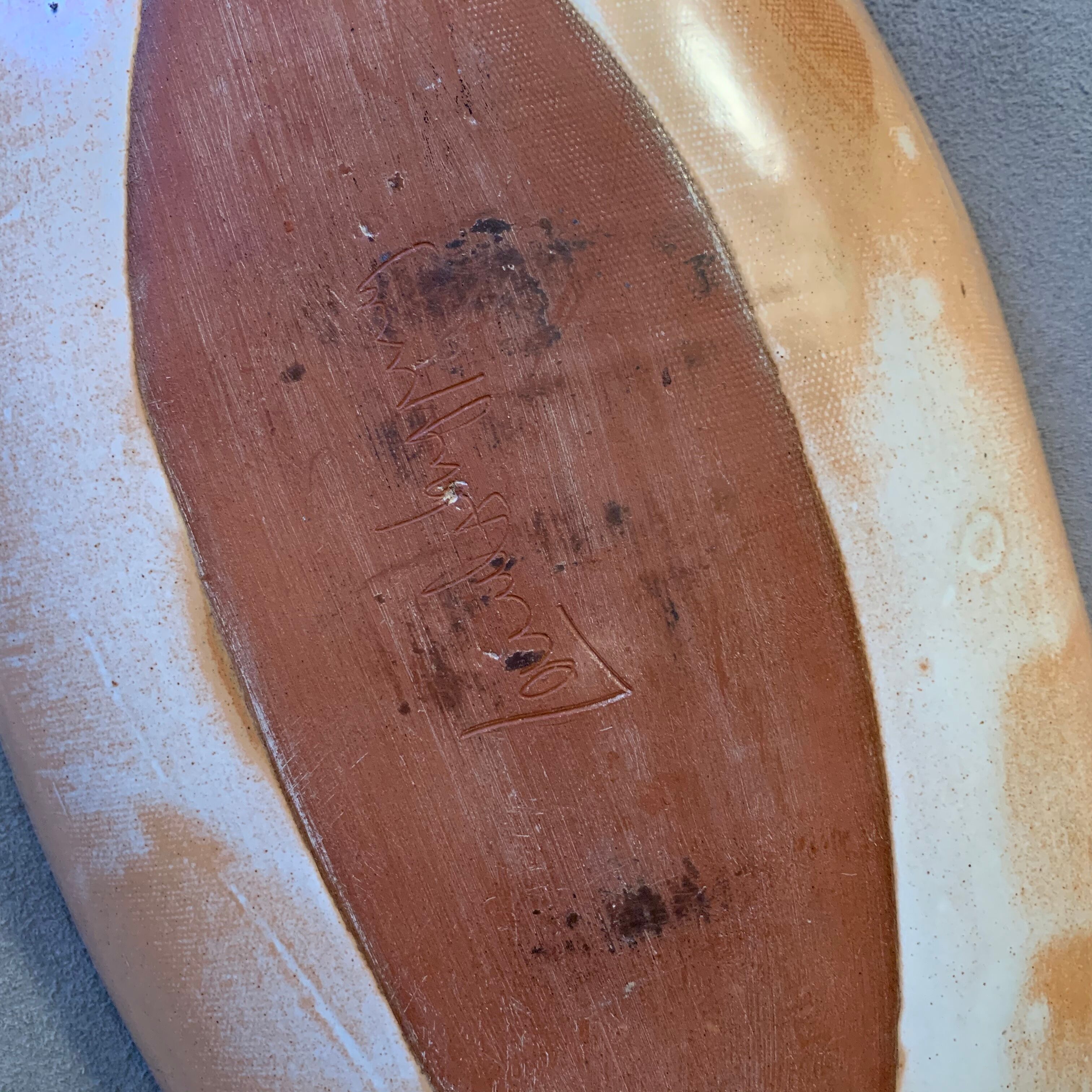 Terracotta /sandstone dish signed with fish drawing