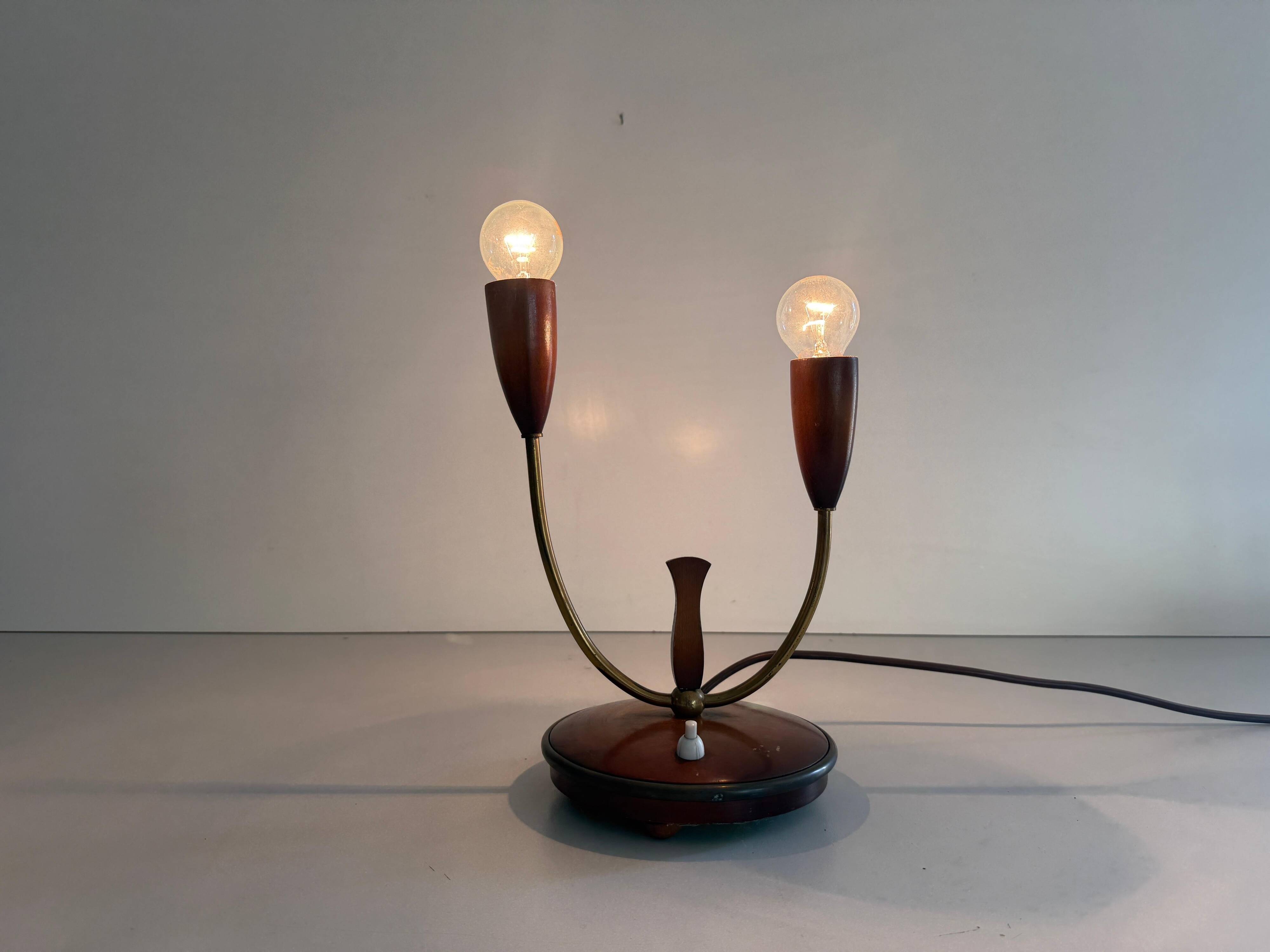 Simple double-headed table lamp in wood and brass, 1960s, Germany.