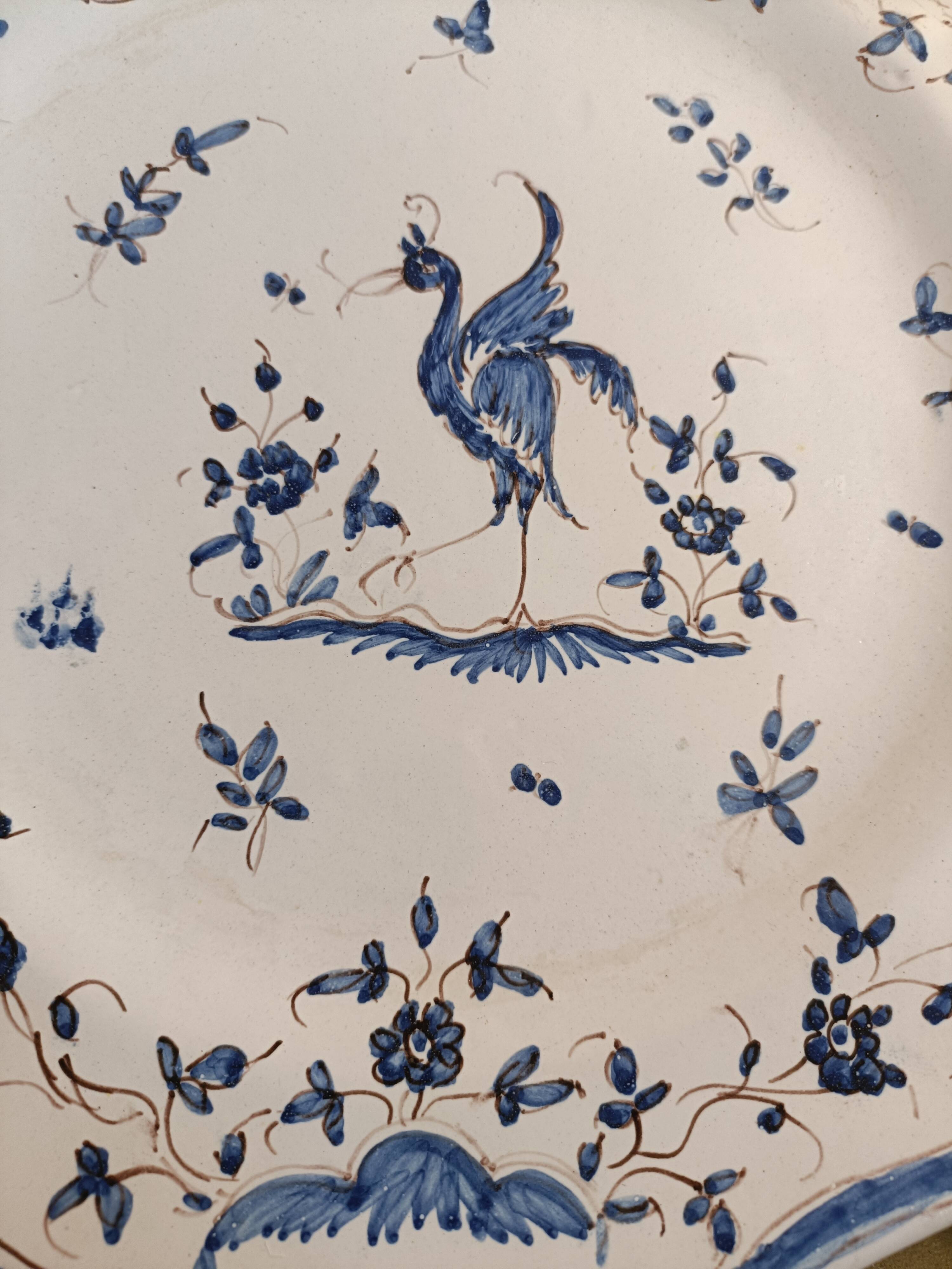 Old Moustiers faience plate blue and white with blue ibis decoration.