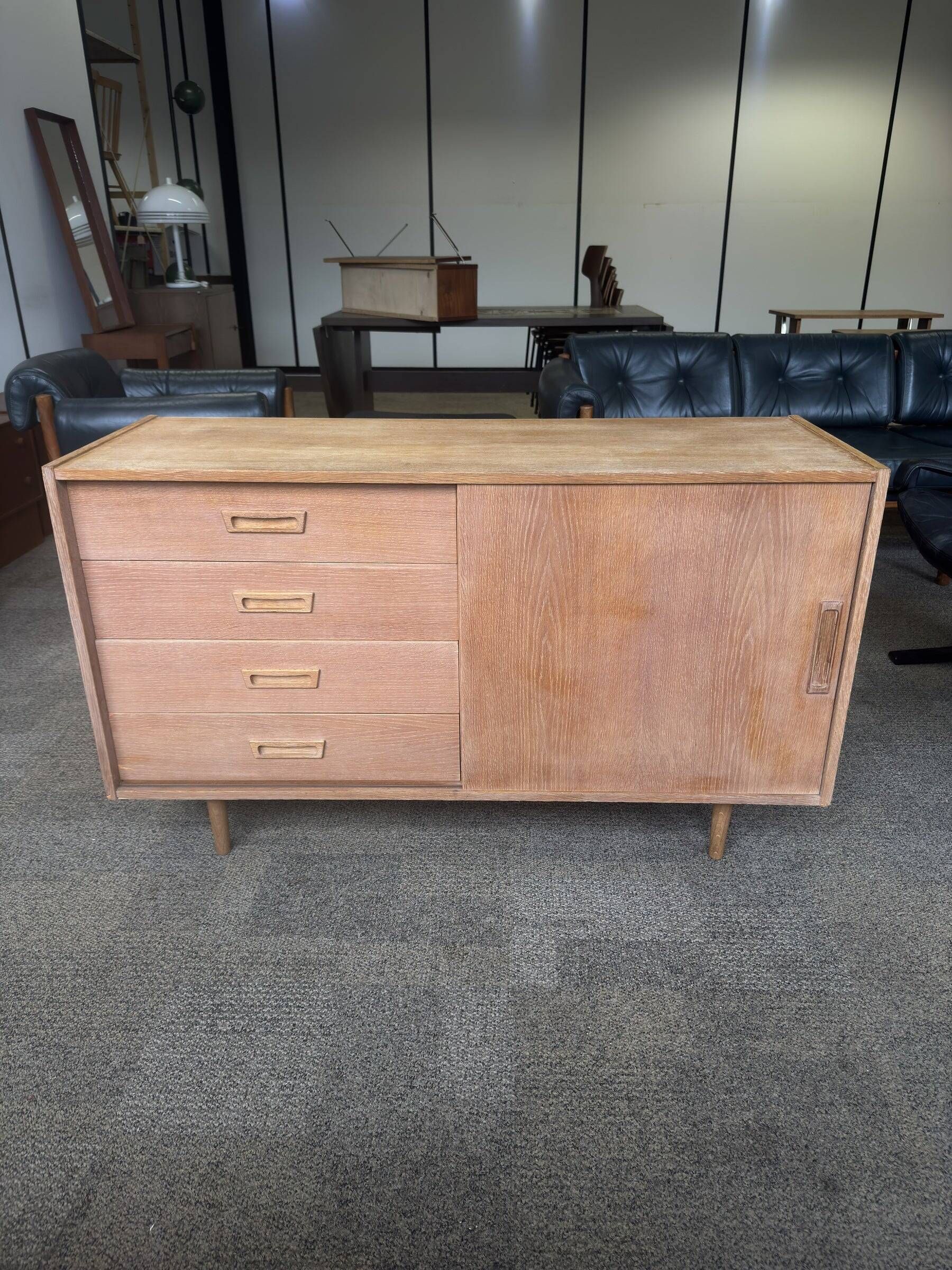 Danish buffet in light oak with sliding door and four drawers.