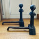 Pair of massive antique-style fire dogs in solid iron from the 20th century.