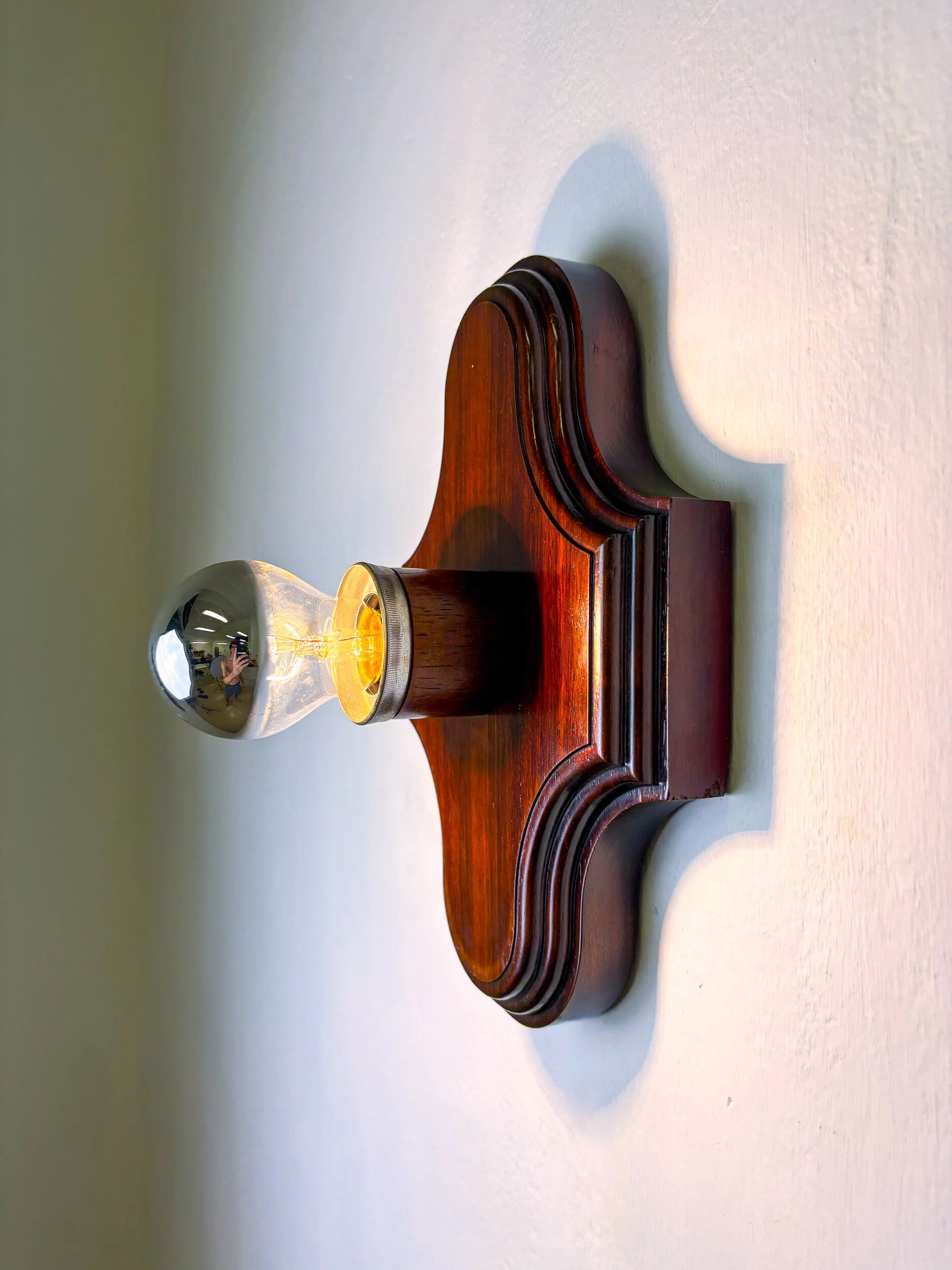 Pair of geometric Art Deco wall lights, carved wood, France, 1960s