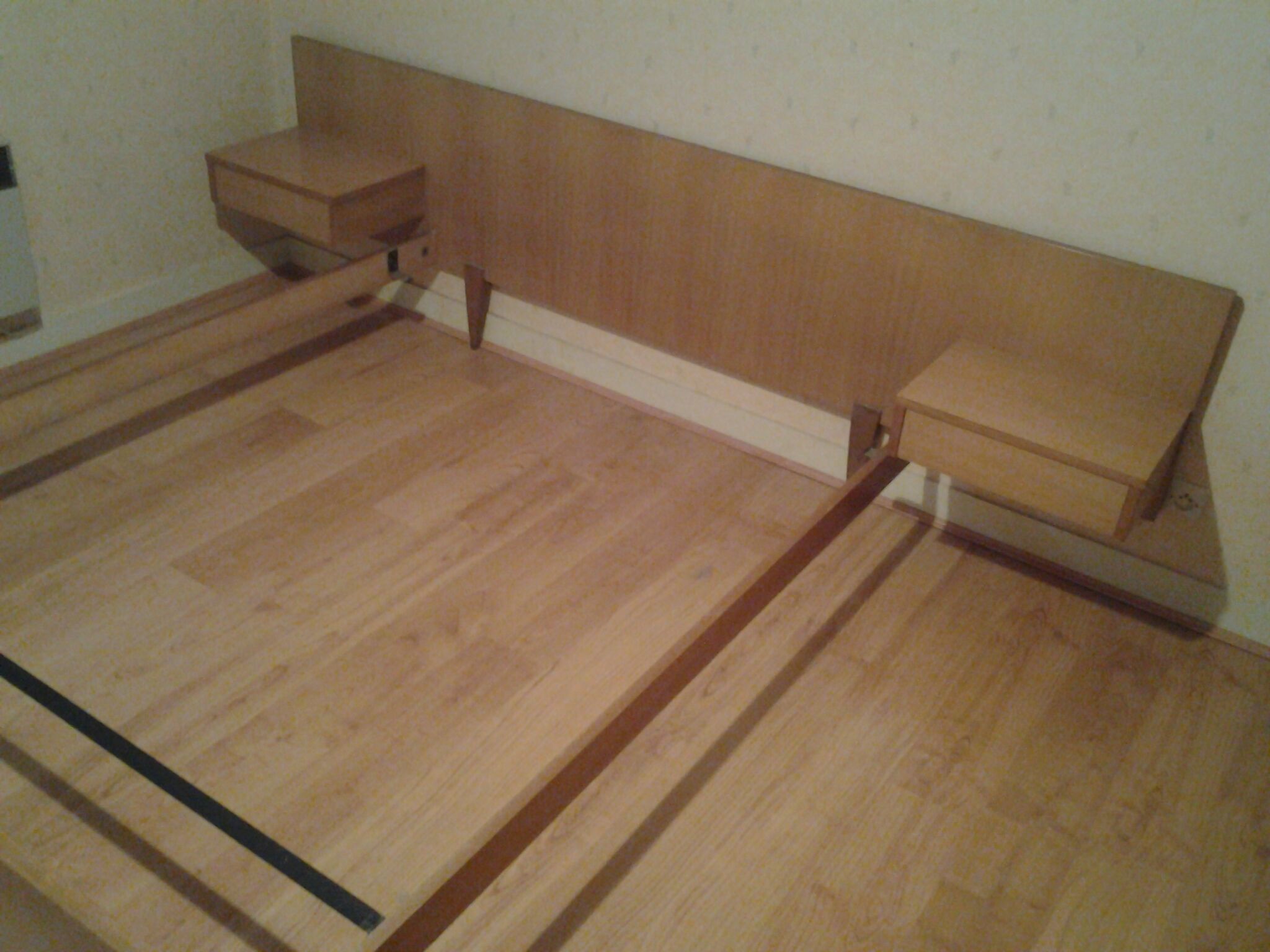 Bed with integrated bedside tables