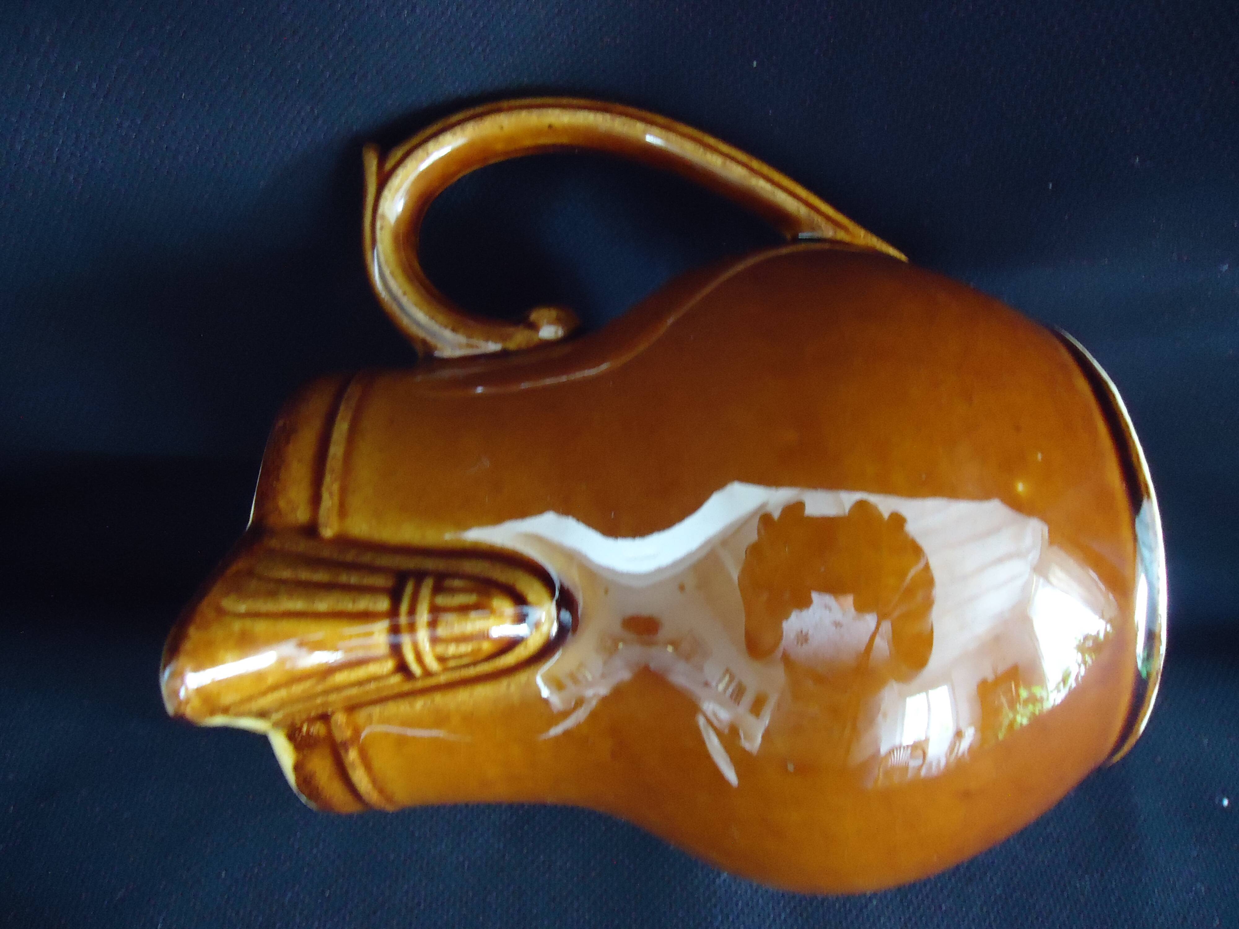 Old covered milk jug, side handle