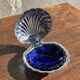 Vintage silver-plated shell butter dish with blue bowl.