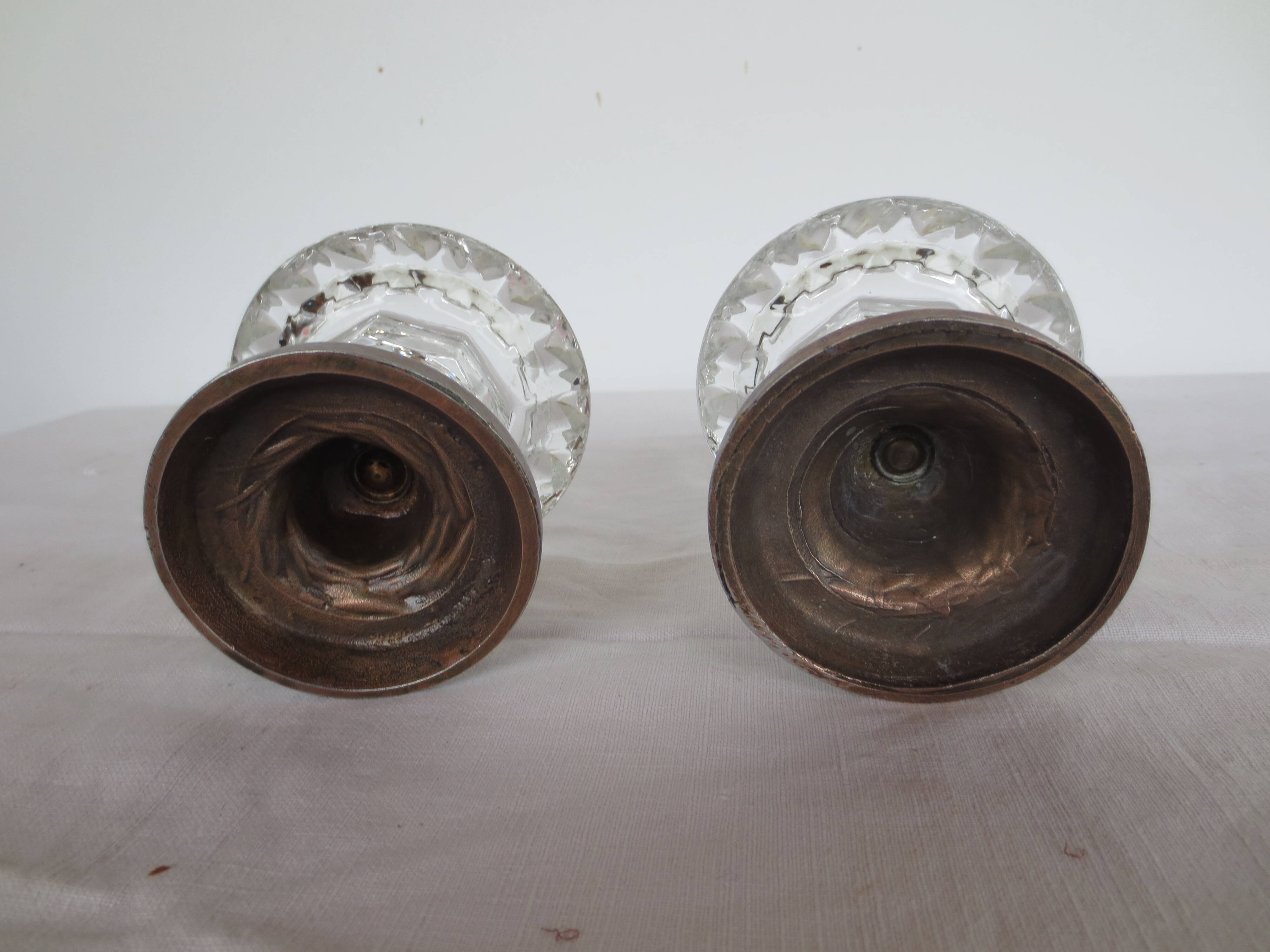 Two candle holders in bronze and crystal