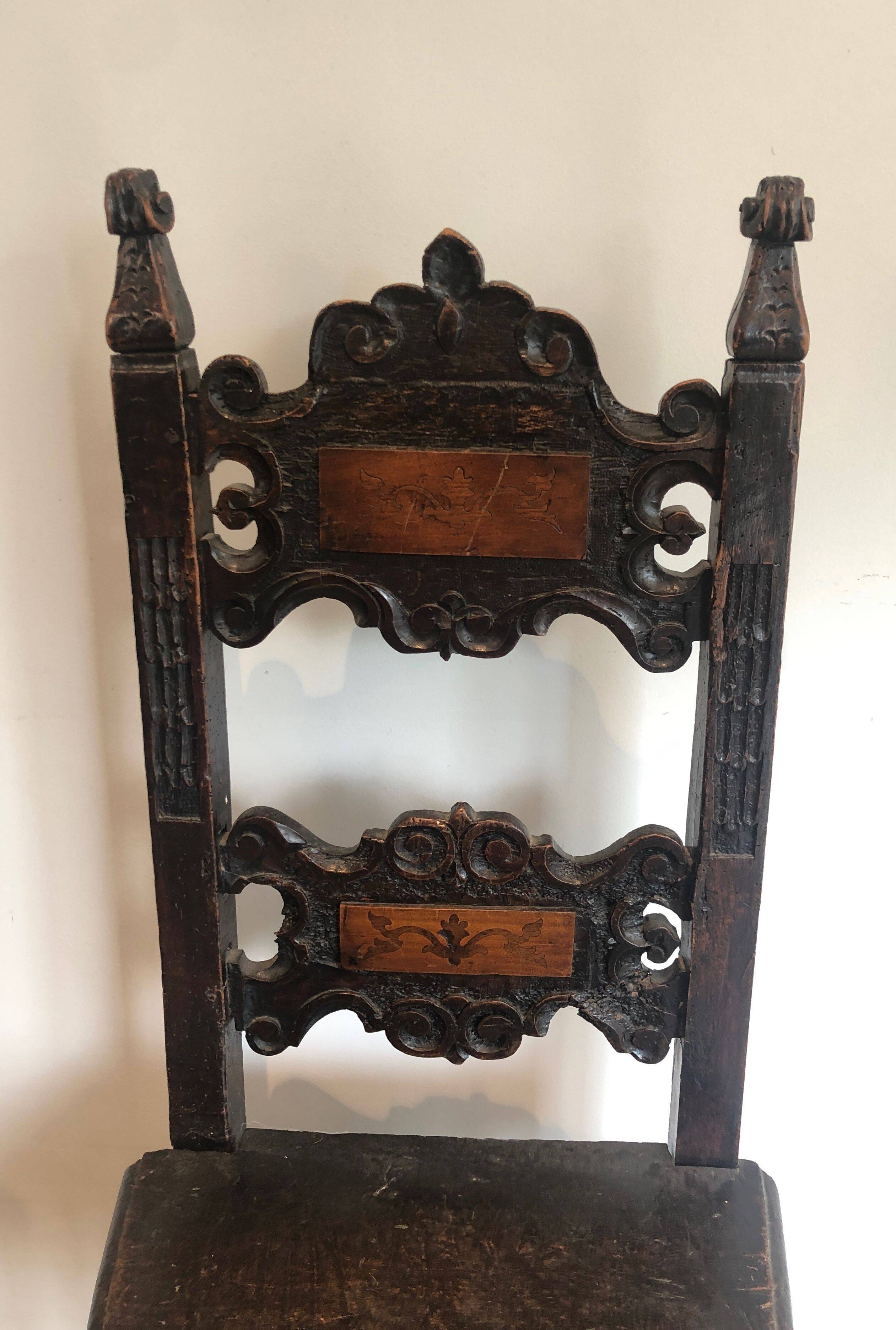 Set of an armchair and a pair of chairs in Italian Renaissance walnut