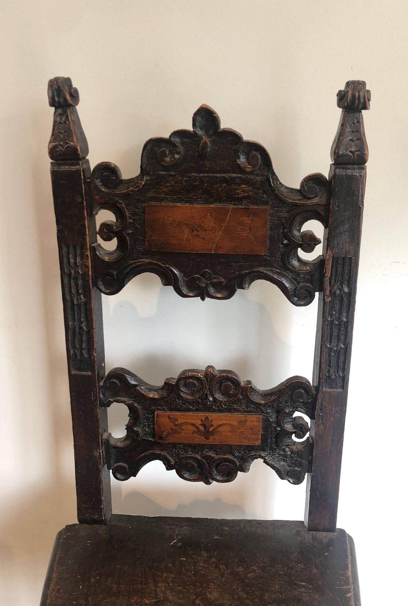 Set of an armchair and a pair of chairs in Italian Renaissance walnut