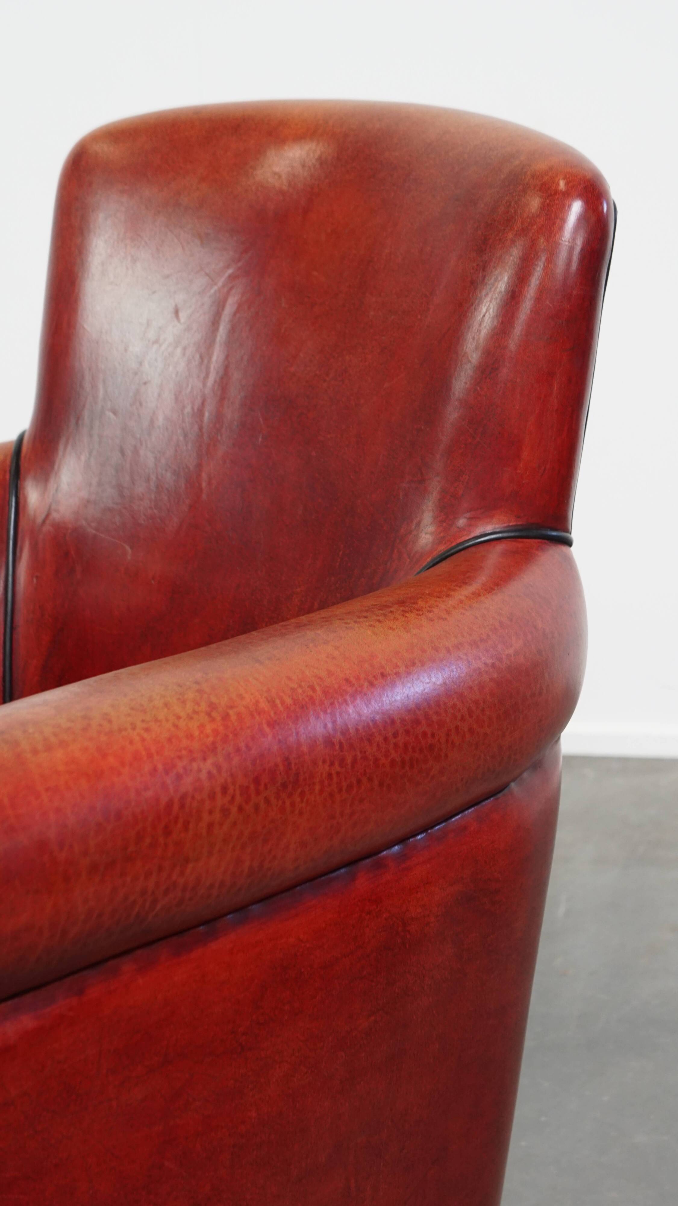 Armchair made of sheepskin leather in a red/brown color
