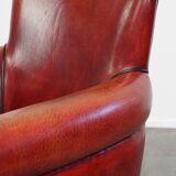 Armchair made of sheepskin leather in a red/brown color