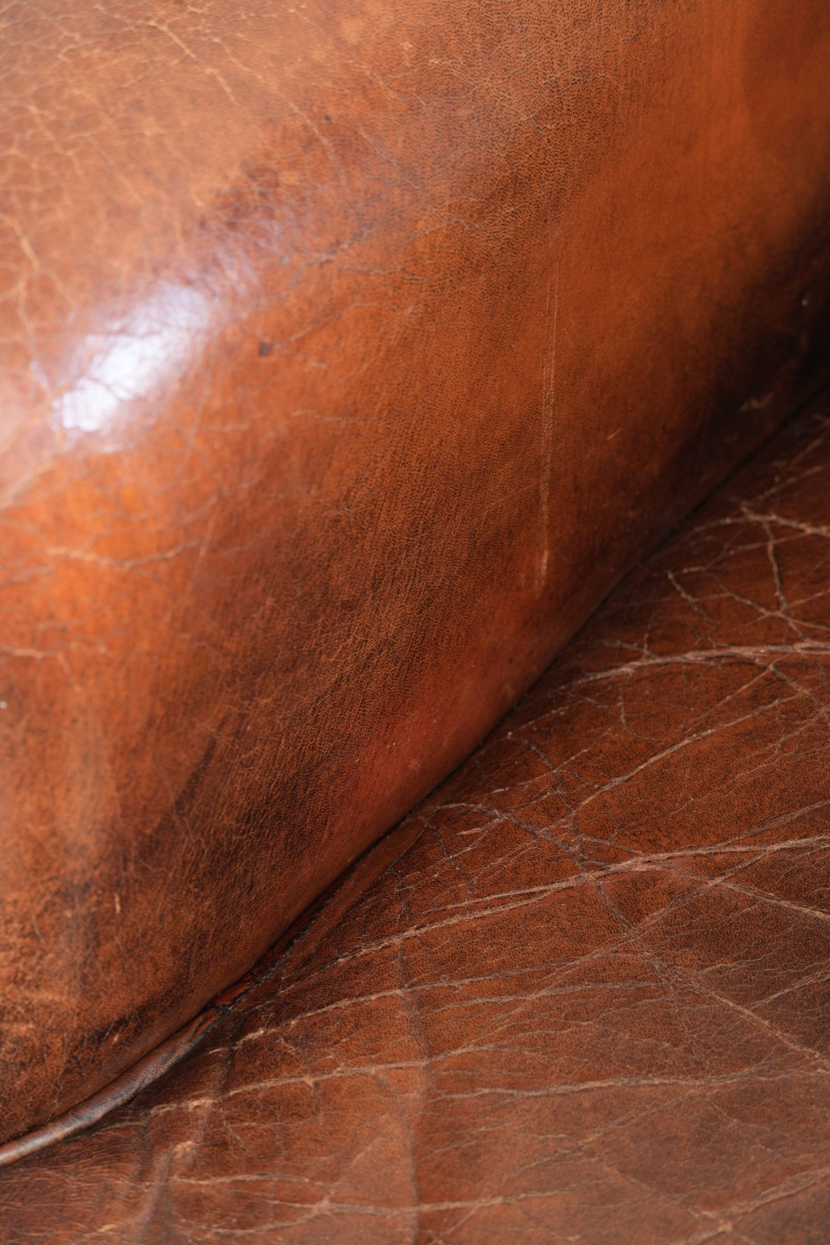 Vintage sheepskin wingback armchair in a deep brown colour finished