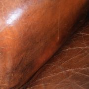 Vintage sheepskin wingback armchair in a deep brown colour finished
