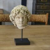 Sculpture of a head in reconstituted stone carved in the antique style of the 19th century