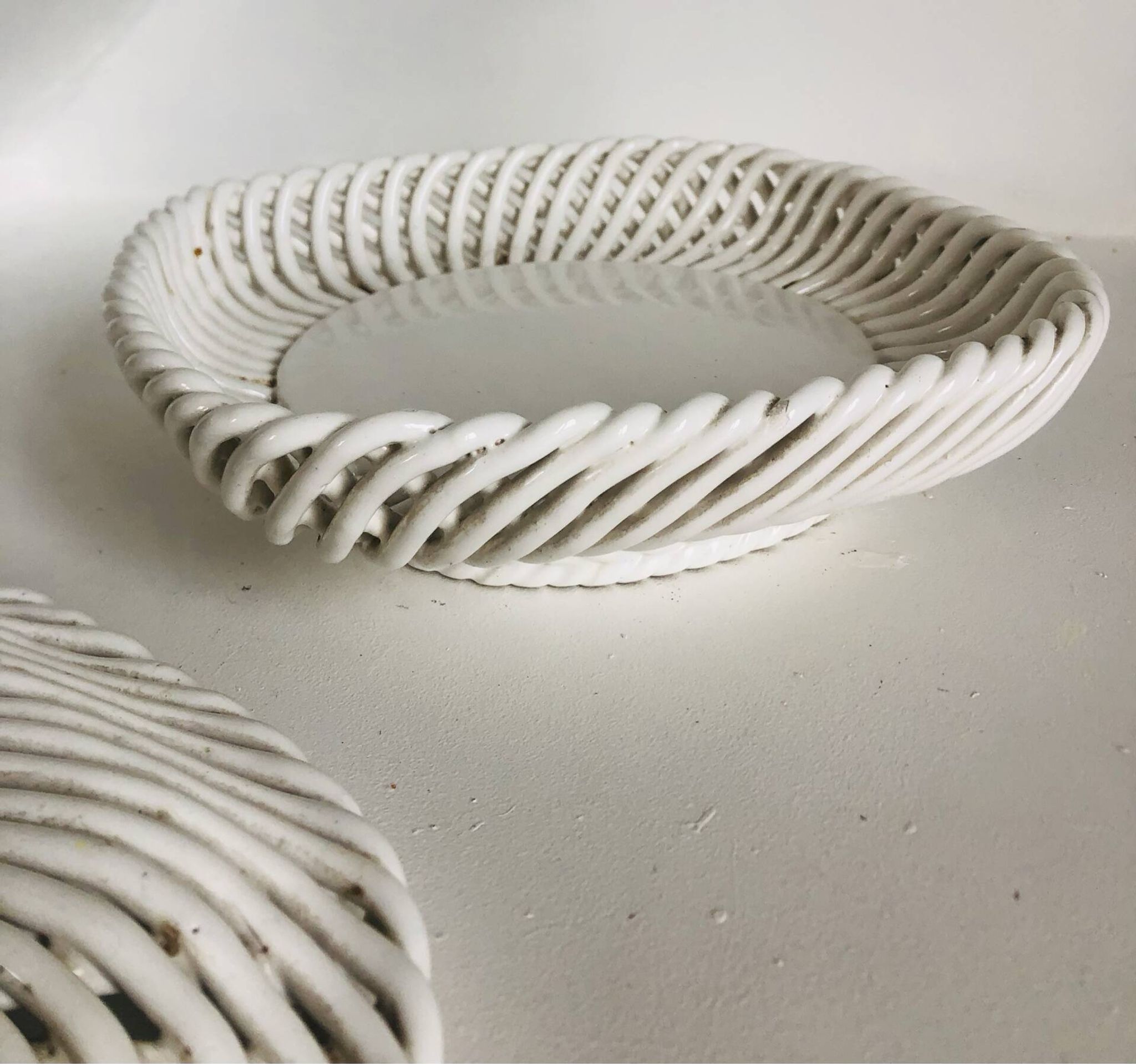 Covered basket in white woven ceramic and fruit slip.