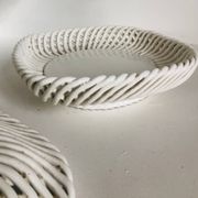 Covered basket in white woven ceramic and fruit slip.