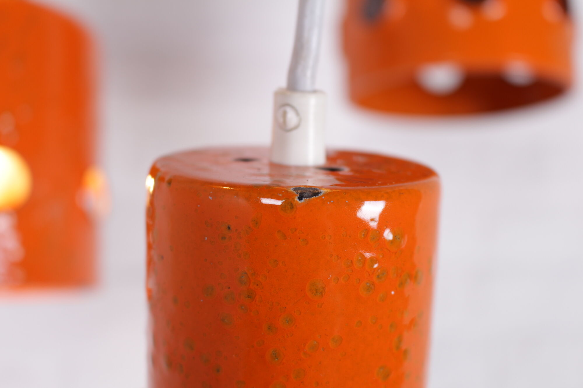 6 Orange enamelled metal suspensions, 1960s