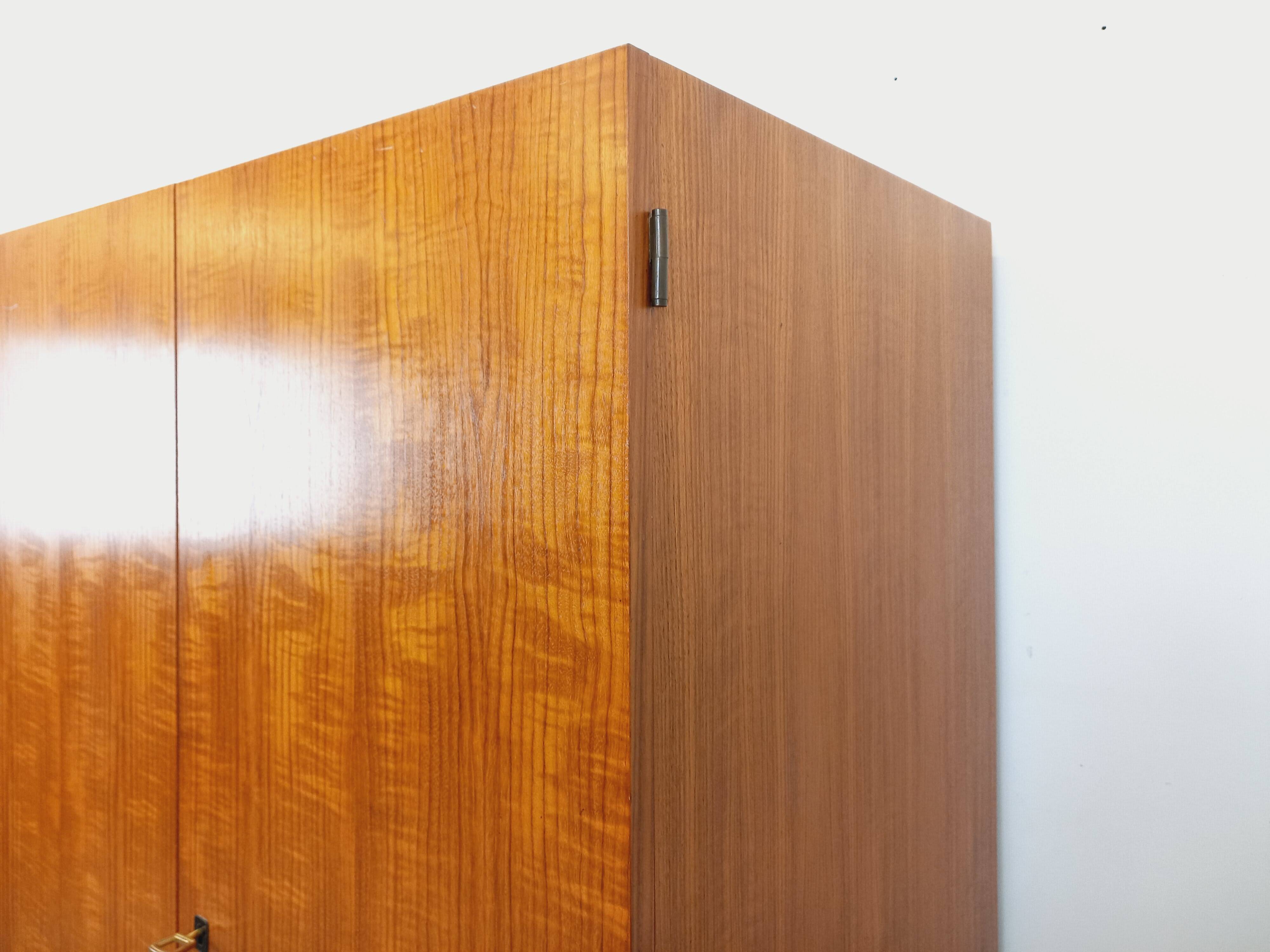 Vintage modernist wardrobe in teak and metal from the 1960s.