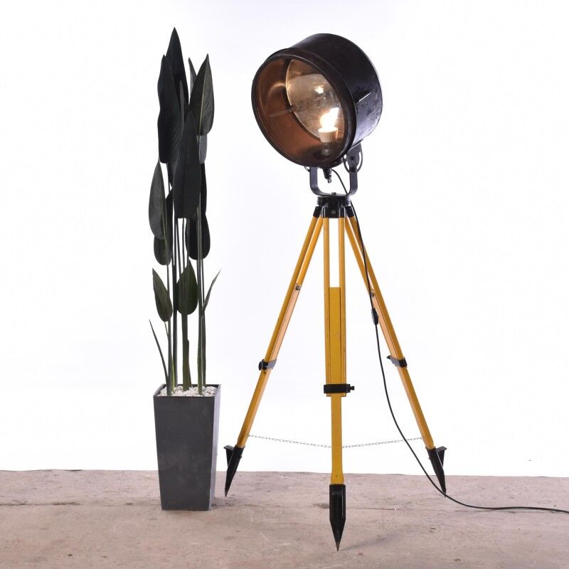Old industrial spot on wooden tripod