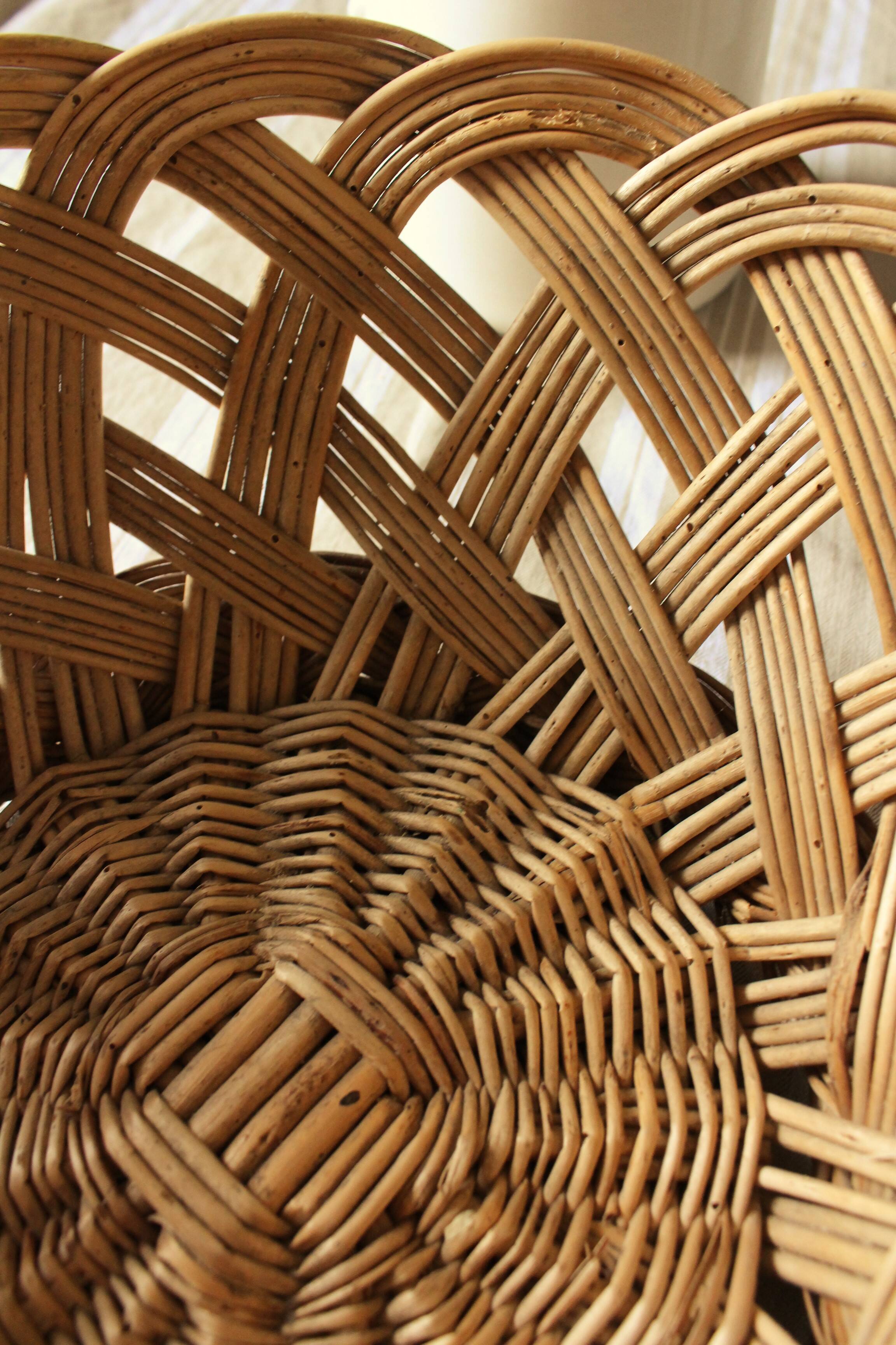 Large vintage twisted wicker basket on a stand