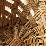 Large vintage twisted wicker basket on a stand