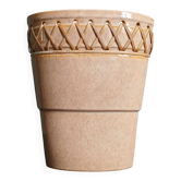 Flat ceramic vase with openwork and woven rattan.