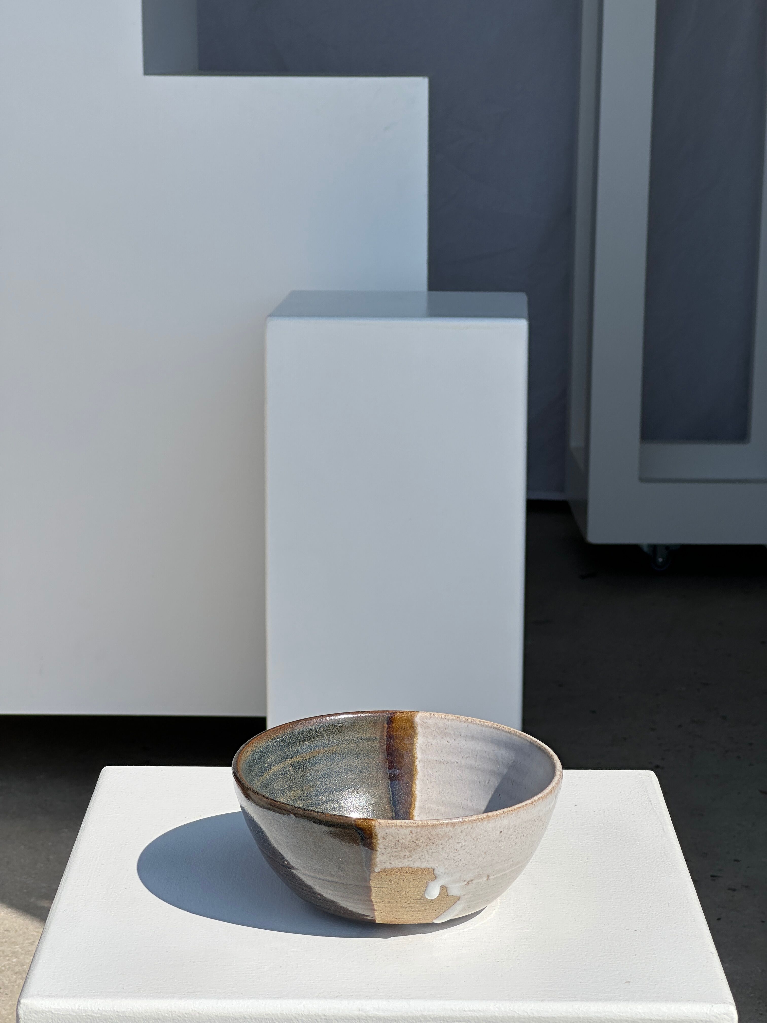 White and glossy brown two-tone ceramic bowl, matt earth