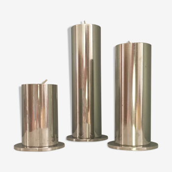 Suite of three brushed steel candlesticks from the 1970s