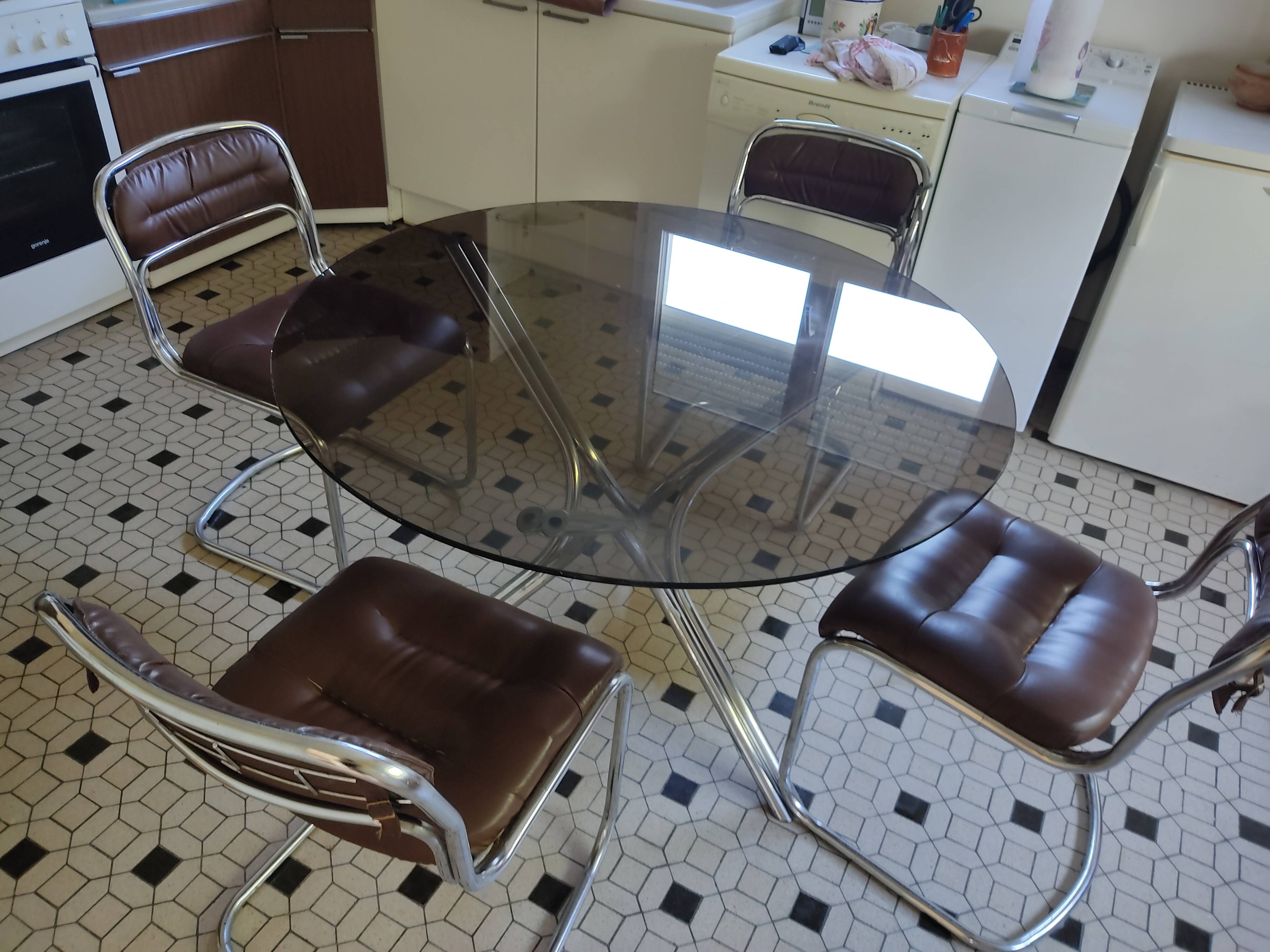 Round kitchen table with smoked glass top and 4 chairs from the 1970s.